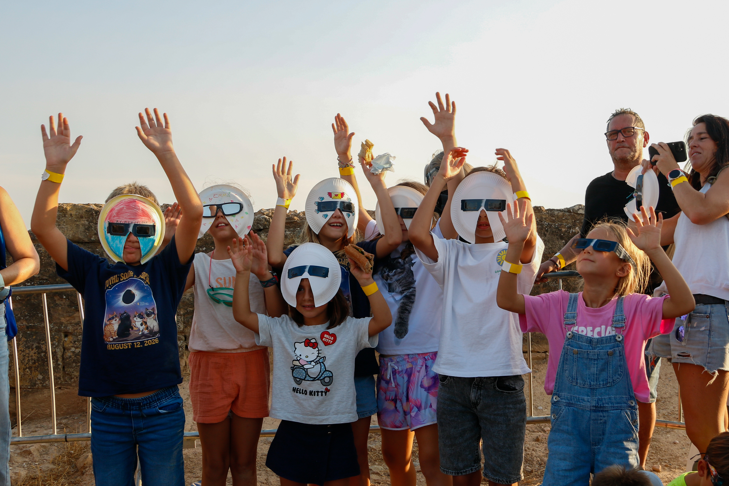 A group of children with homemade masks watch the eclipse in Lleida