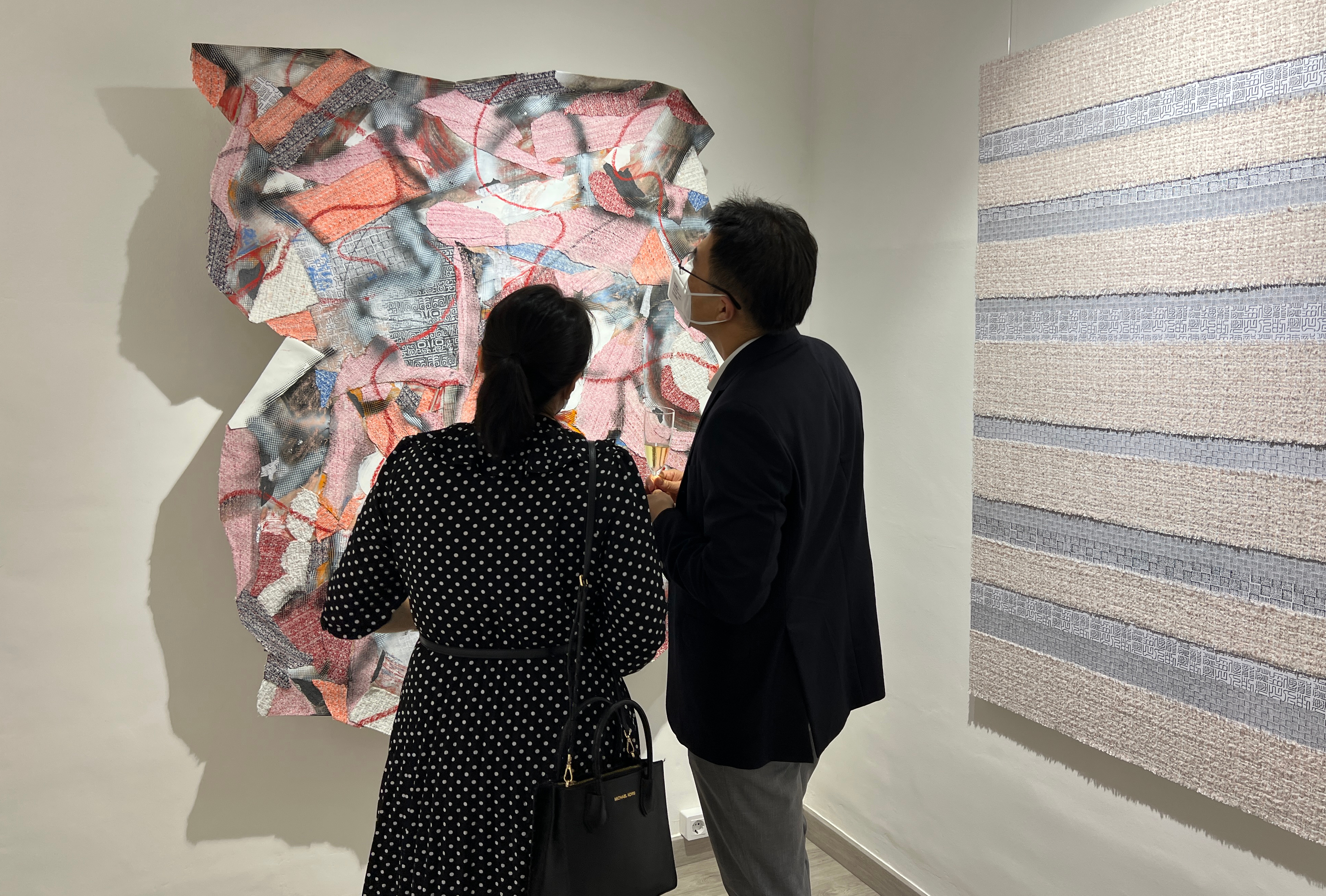 Two NoHo House visitors watch Phil Akashi's artwork on September 14, 2022