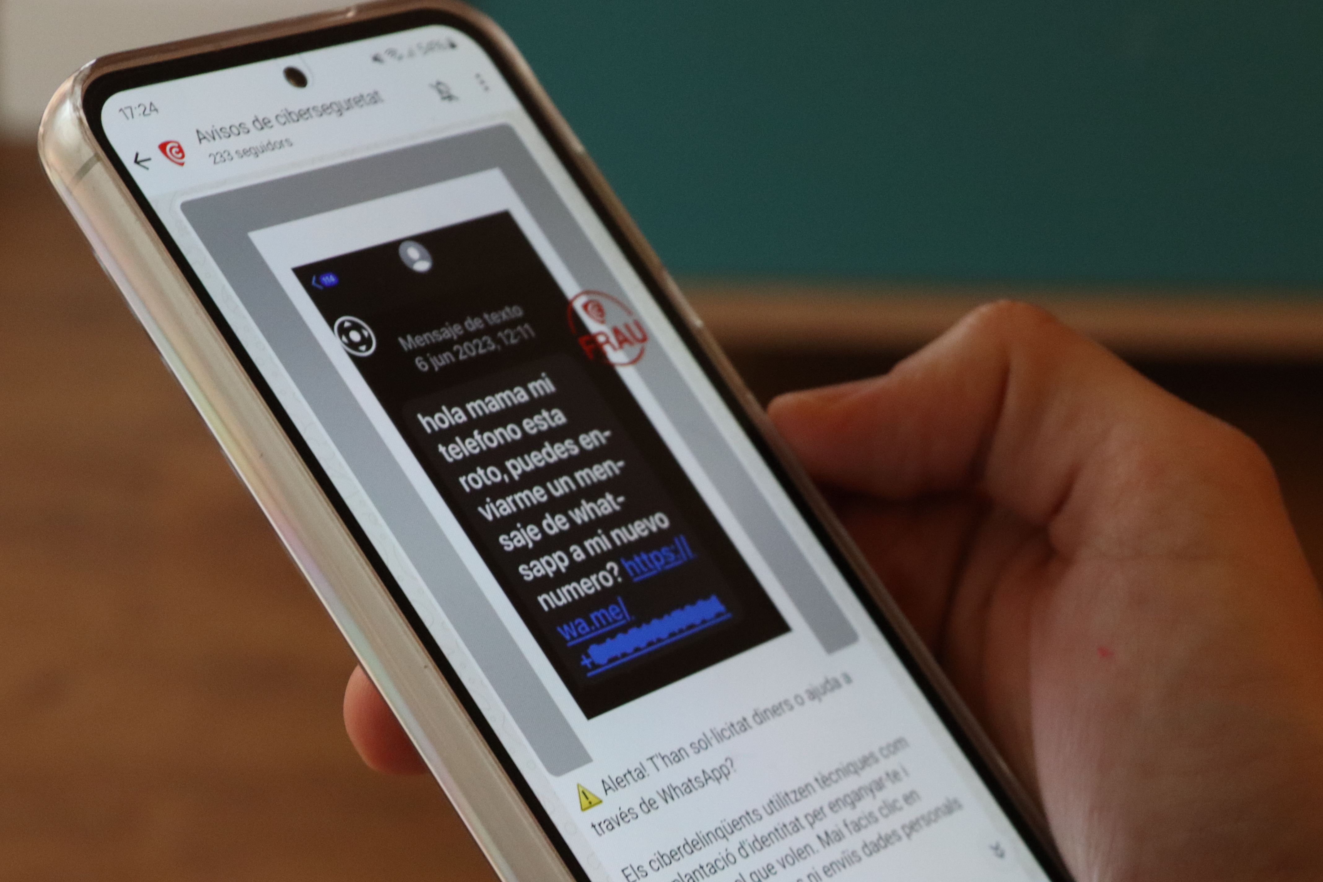 A phone displaying the WhatsApp channel of the Catalan Cybersecurity Agency, which informs citizens about the latest cyber-scams
