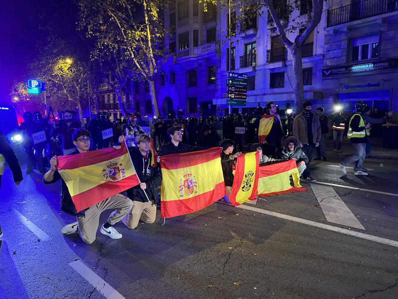 Demonstrators with Spanish flags during the 14th night of protests in front of the Socialists' headquarters in Madrid