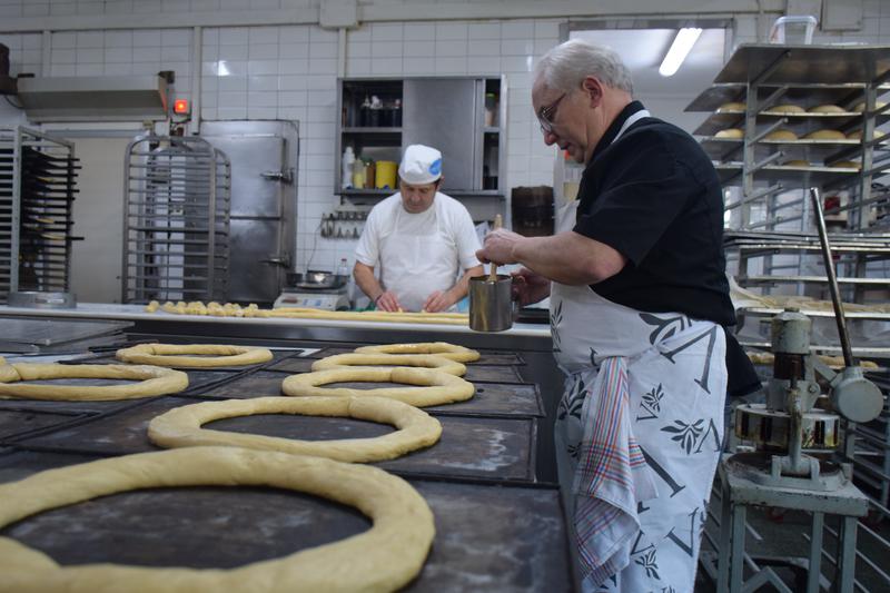 A baker in Barcelona preparing tortell de Reis
