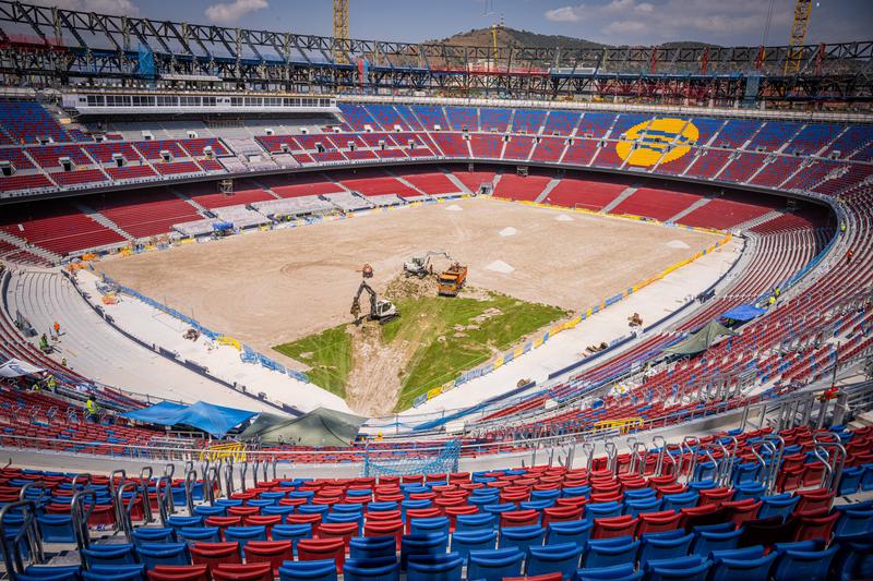 FC Barcelona's Spotify Camp Nou in mid July during construction works with no grass, with red, blue, and yellow chairs