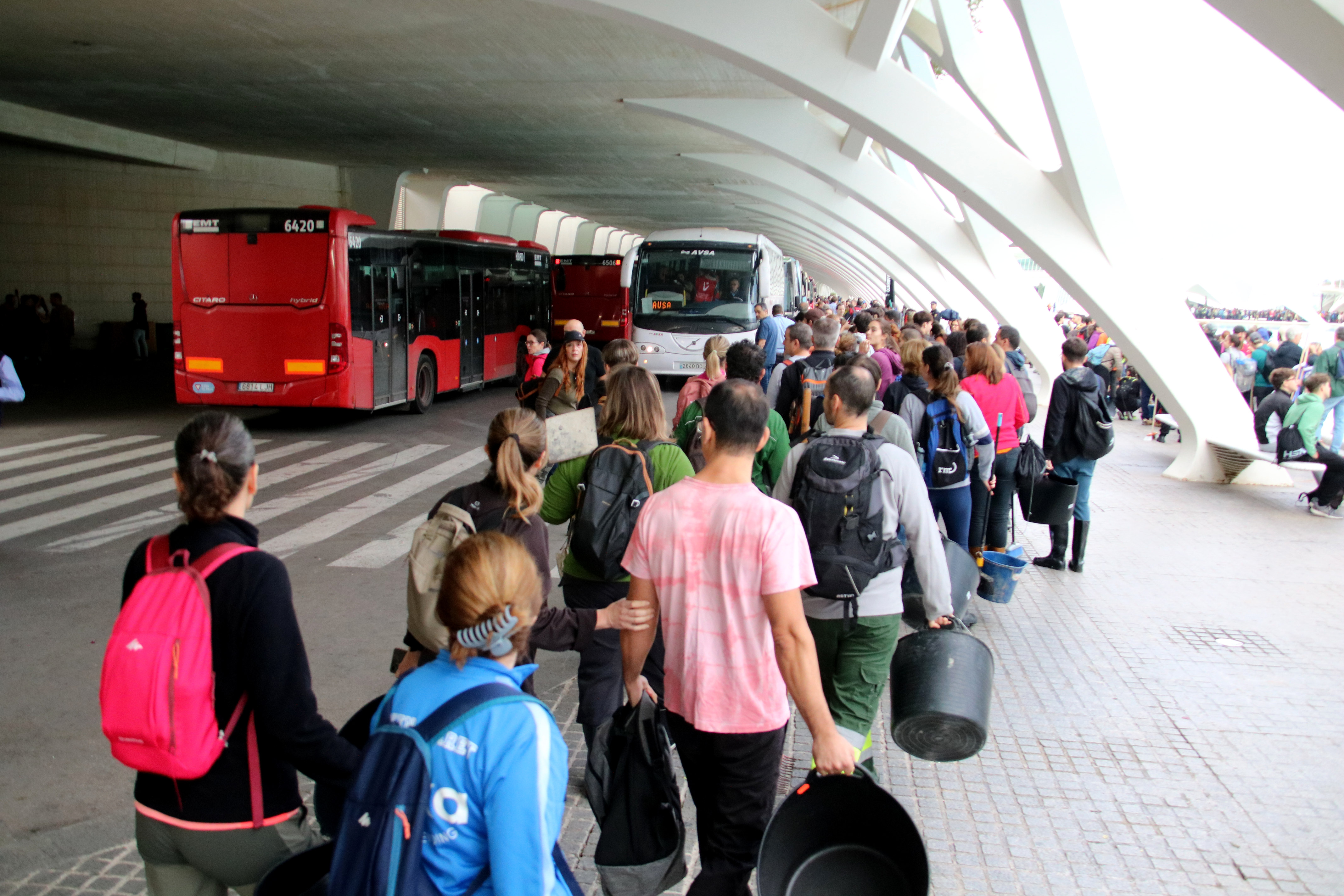 Volunteers prepare to board buses to go to towns affected by the floods