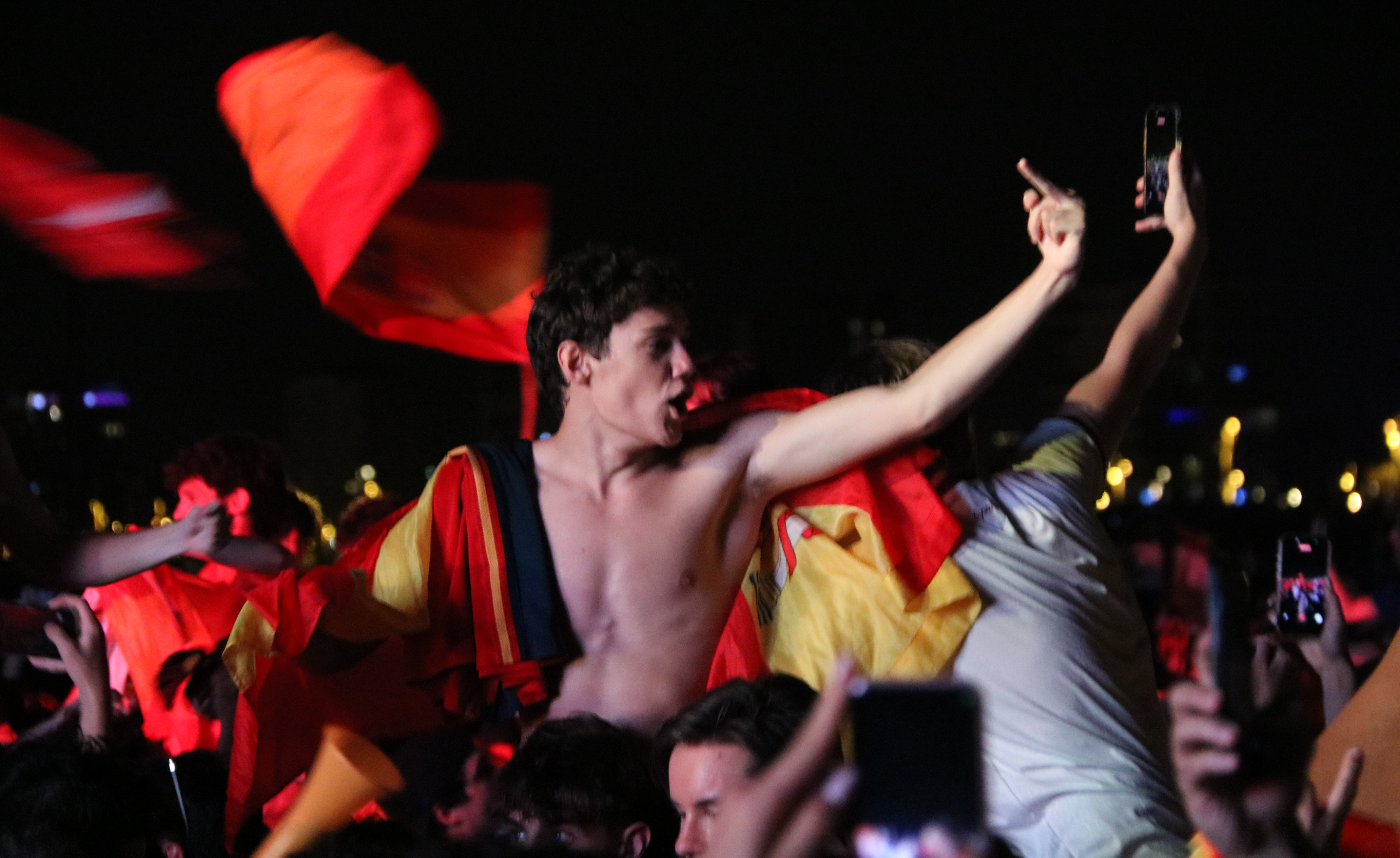 A Spanish fan passionetly addresses the Argentine fans, during the men's World Cup final, in Barcelona