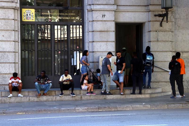 People queuing at the Girona immigration office
