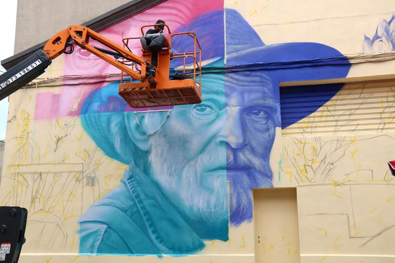 Artist Jotalo painting his mural during Gargar 2025