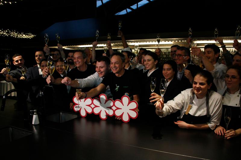 The Torres brothers celebrate receiving three Michelin stars with members of staff at their restaurant Cocina Hermanos Torres