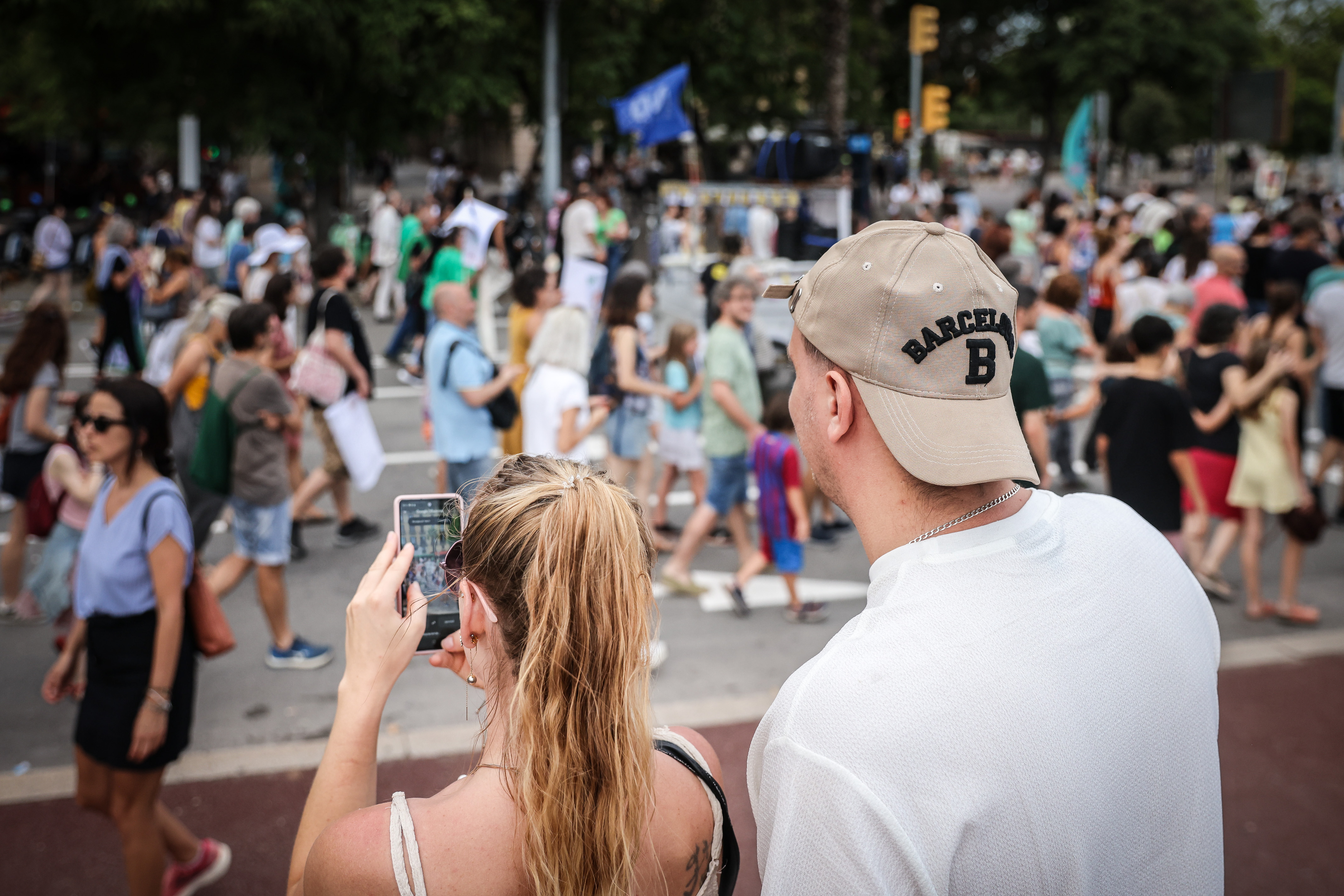 Tourists take a photo during a demonstration against mass tourism in Barcelona on July 6, 2024.