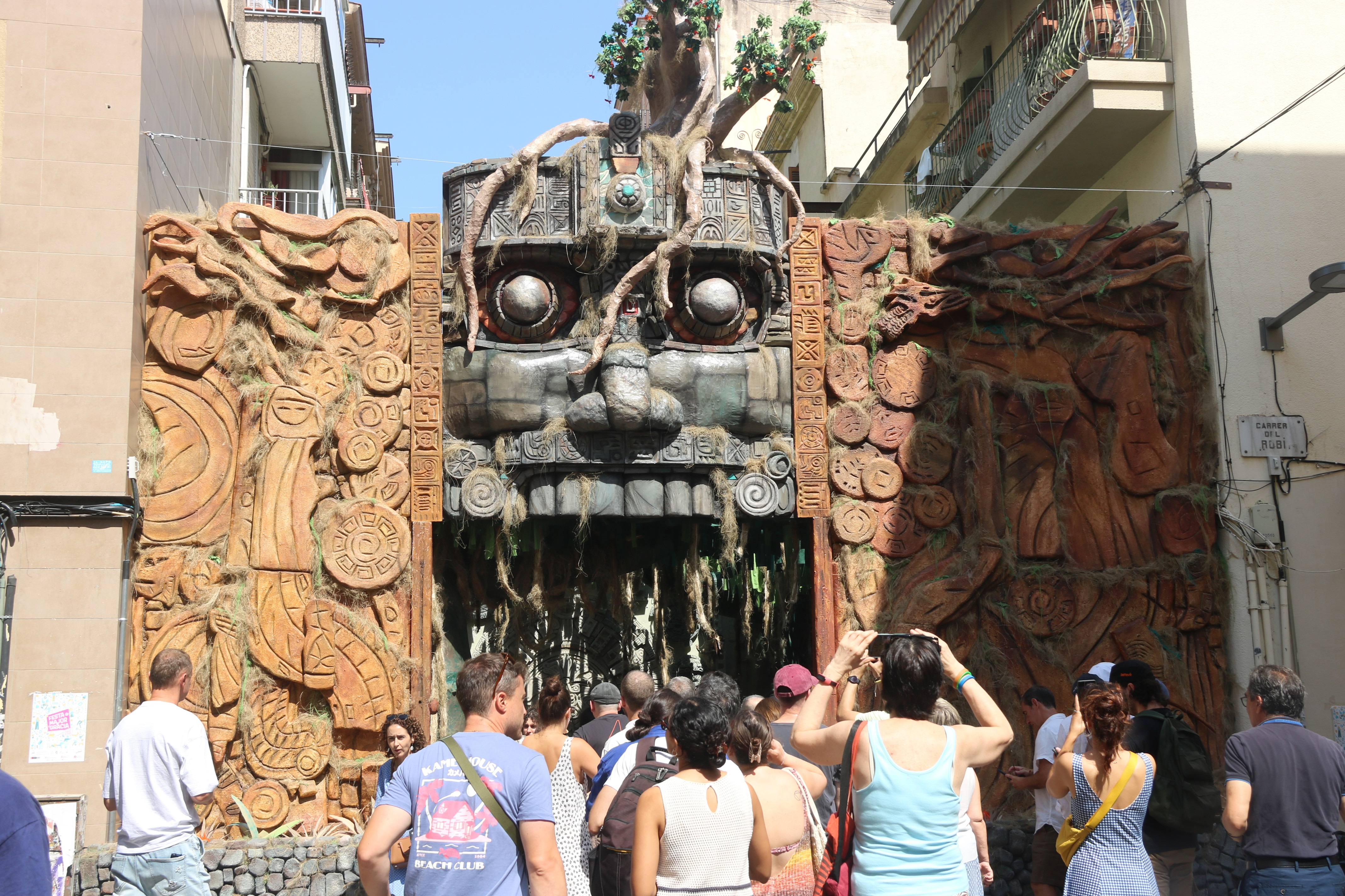 People take photos at the entrance of carrer Verdi during the 2025 Festes de Gràcia