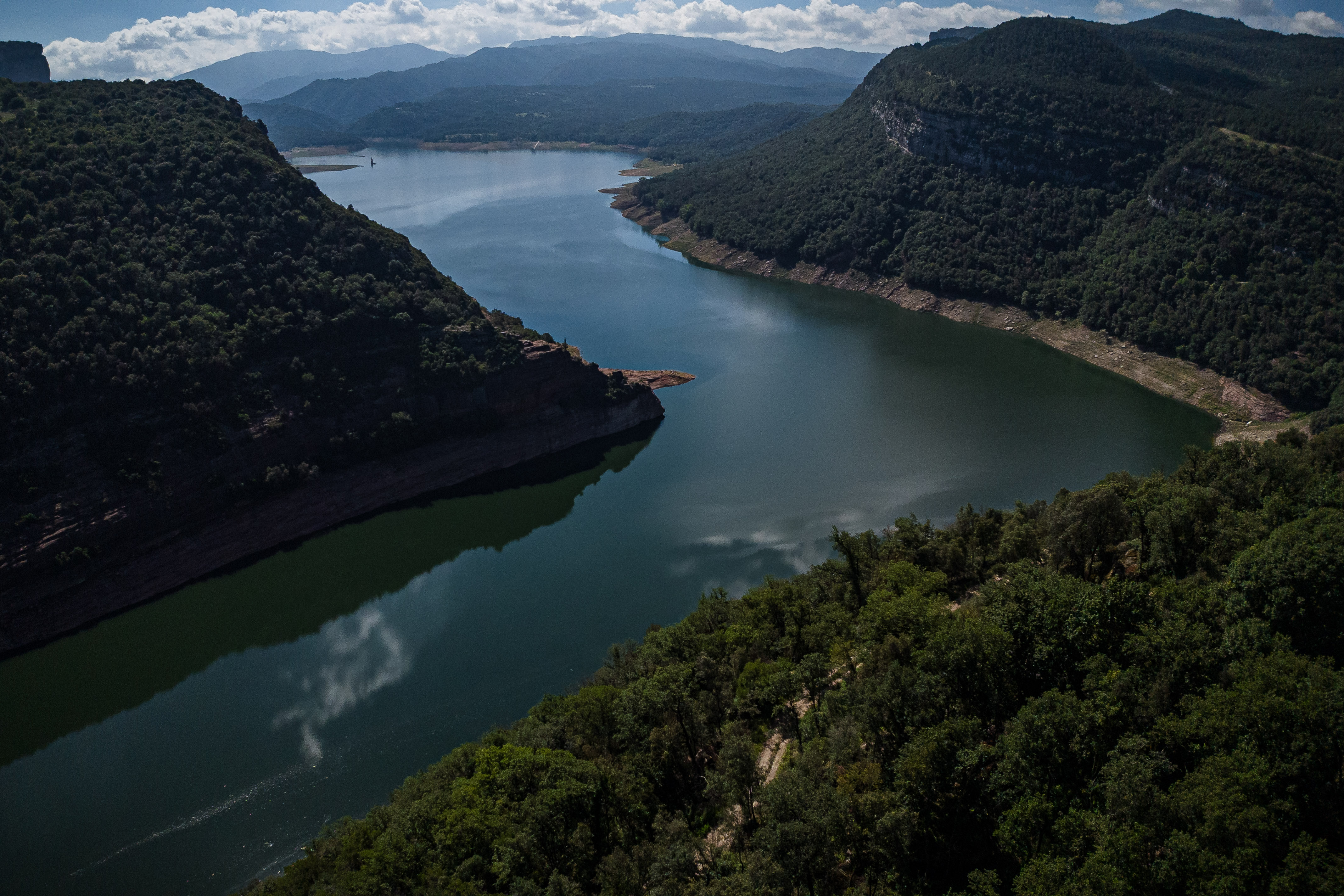 The Pantà de Sau reservoir on June 22, 2024 at 45% of its capacity with a green forest by its side