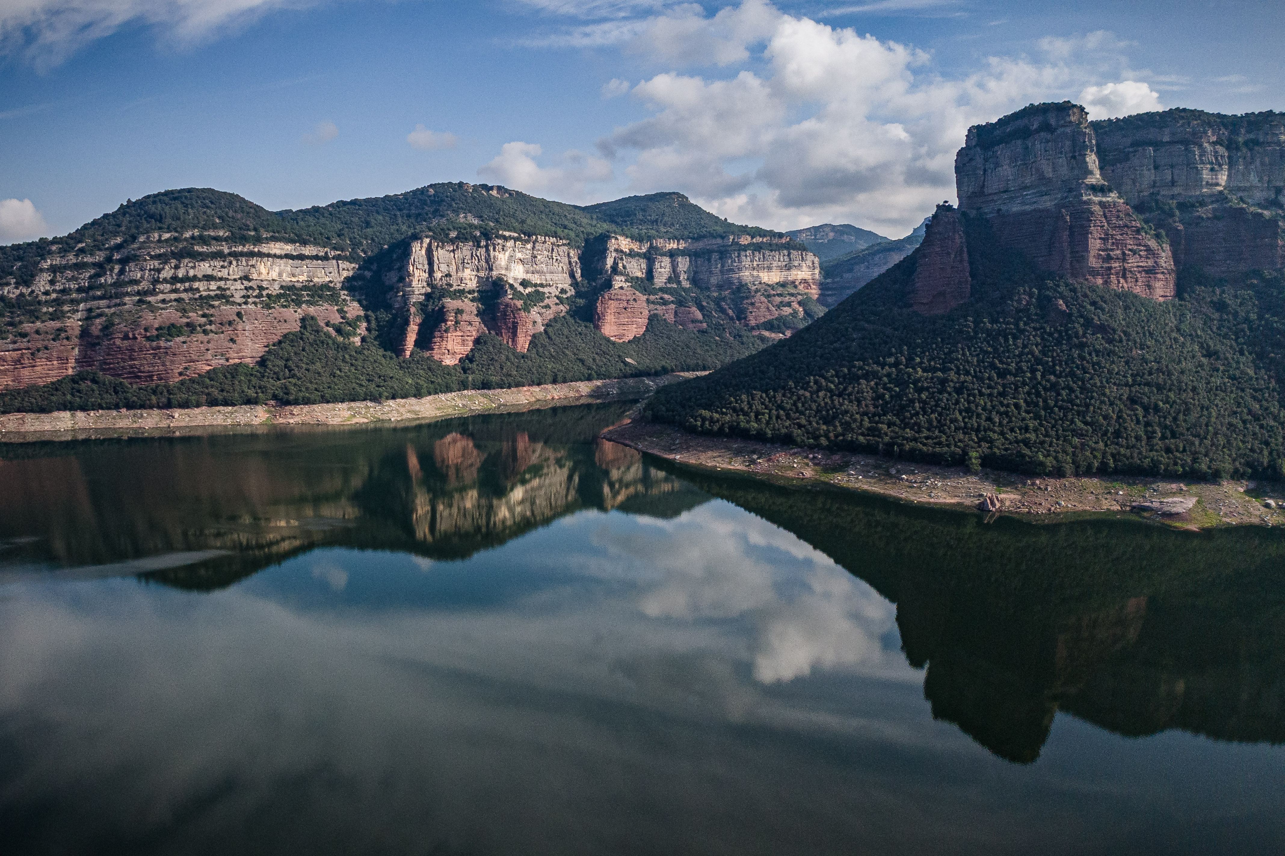 The Pantà de Sau reservoir is surrounded by large mountains