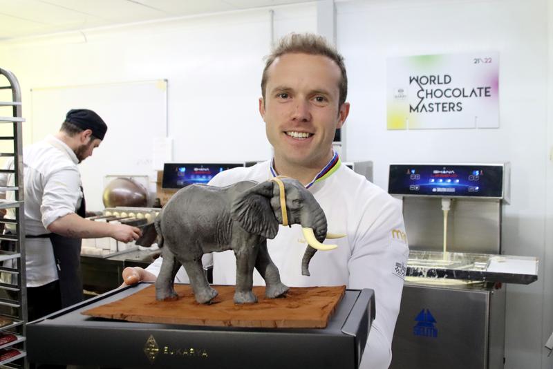 Lluc Crusellas, the world's best master chocolatier, poses with the miniature replica of his title-winning chocolate elephant, available in Easter Cake form in 2023