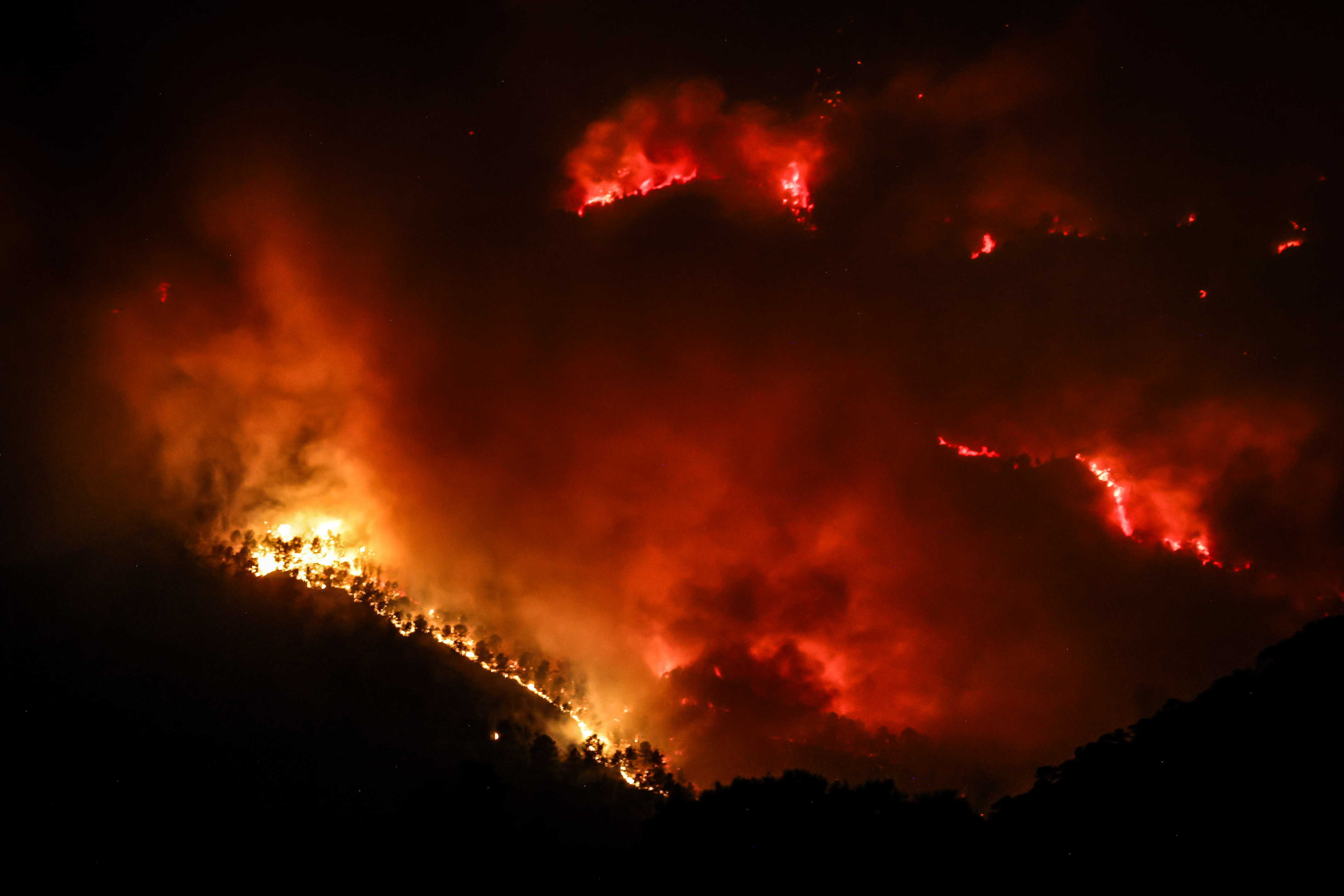 Flames burning in the Parc Natural dels Ports during the Paüls wildfire in July