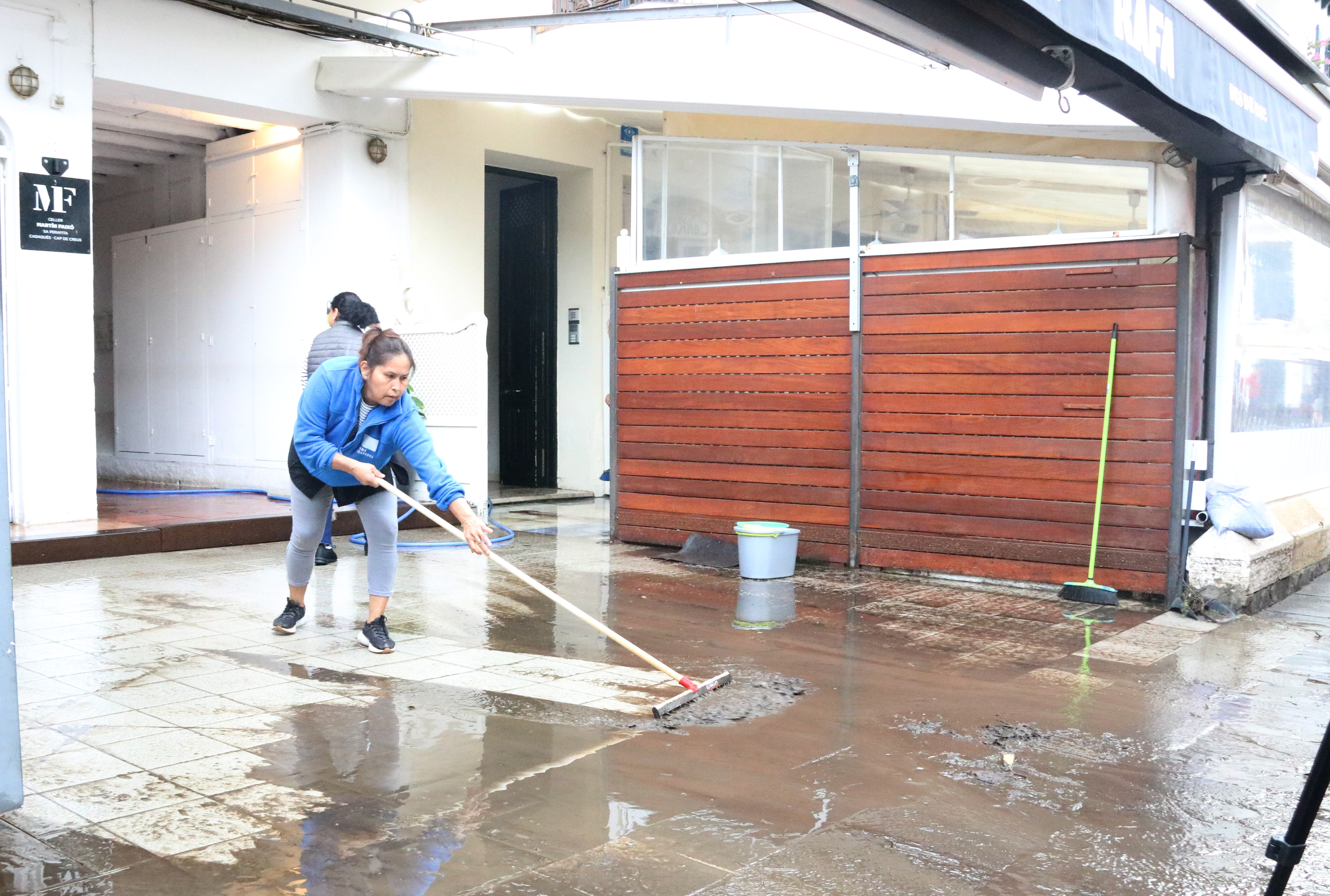 A woman cleans the flooded area in a terrace in Cadaqués on November 8, 2024