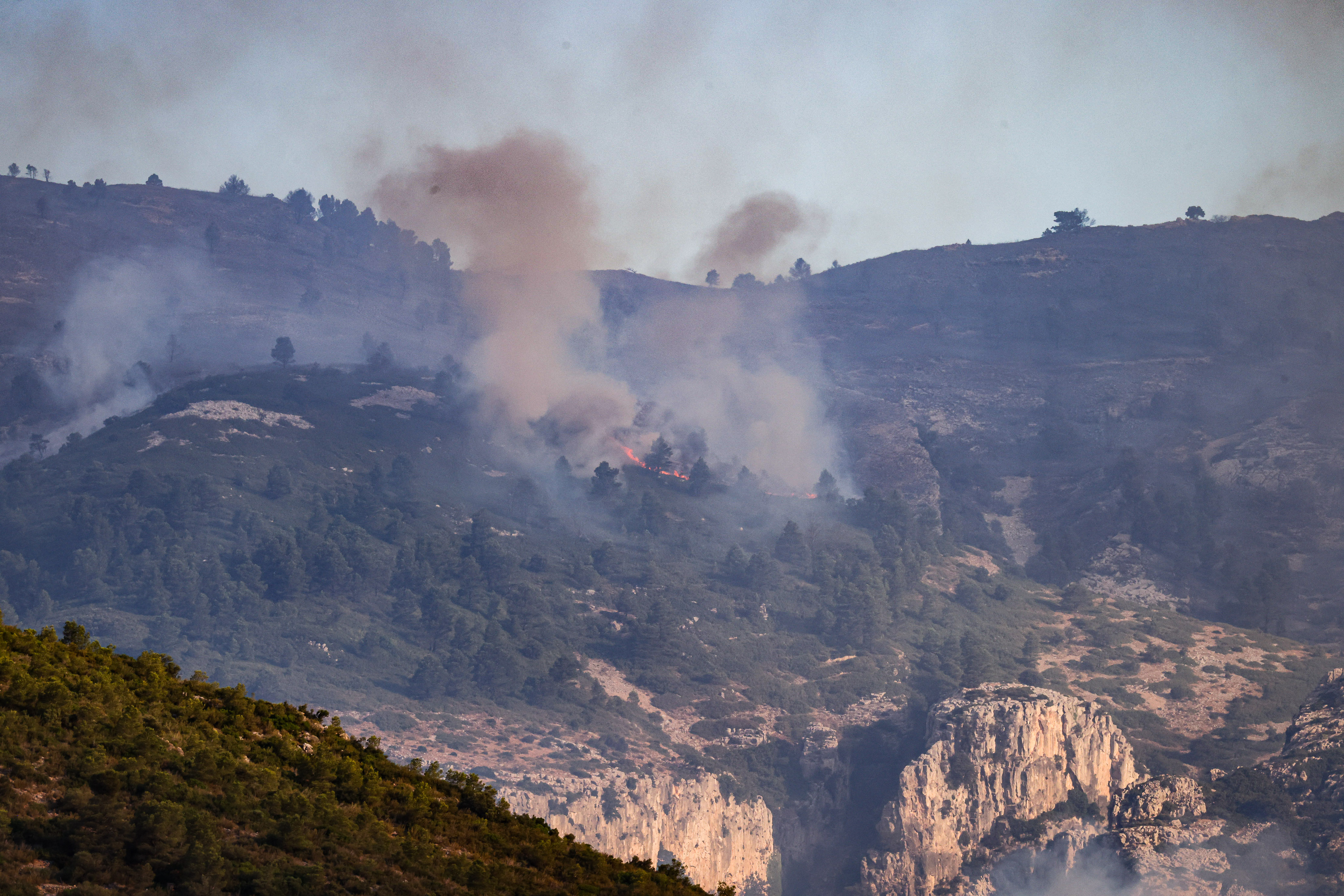 Flames and smoke at the Ports Natural Park in Paüls due to a wildfire