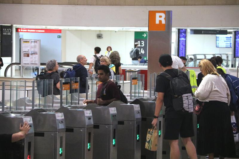 Train passengers at the entrance to the Rodalies services at Sants station.