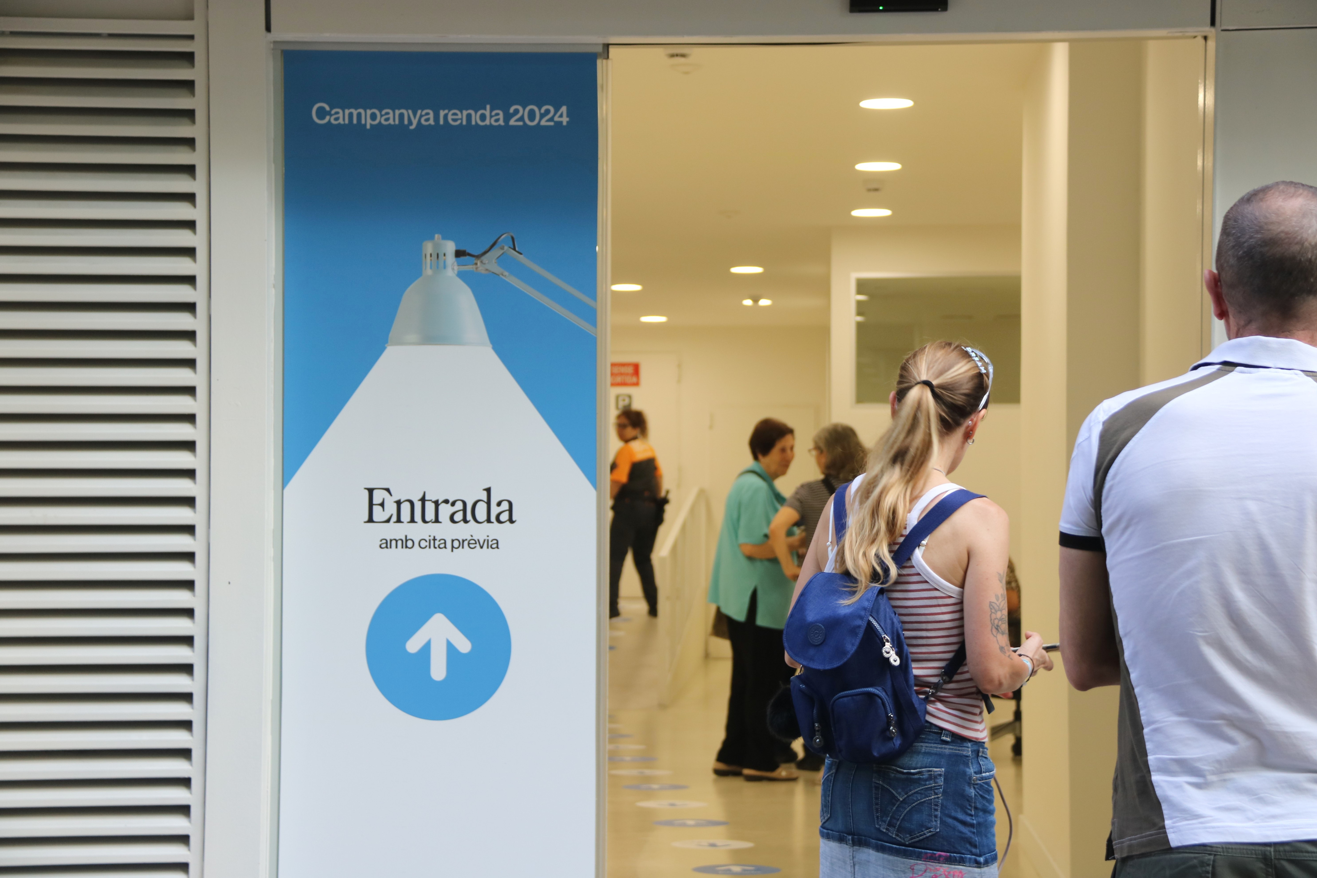 People queuing at an office of the Tax Agency of Catalonia