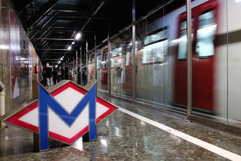 A metro train passing through the Gaudí ghost station