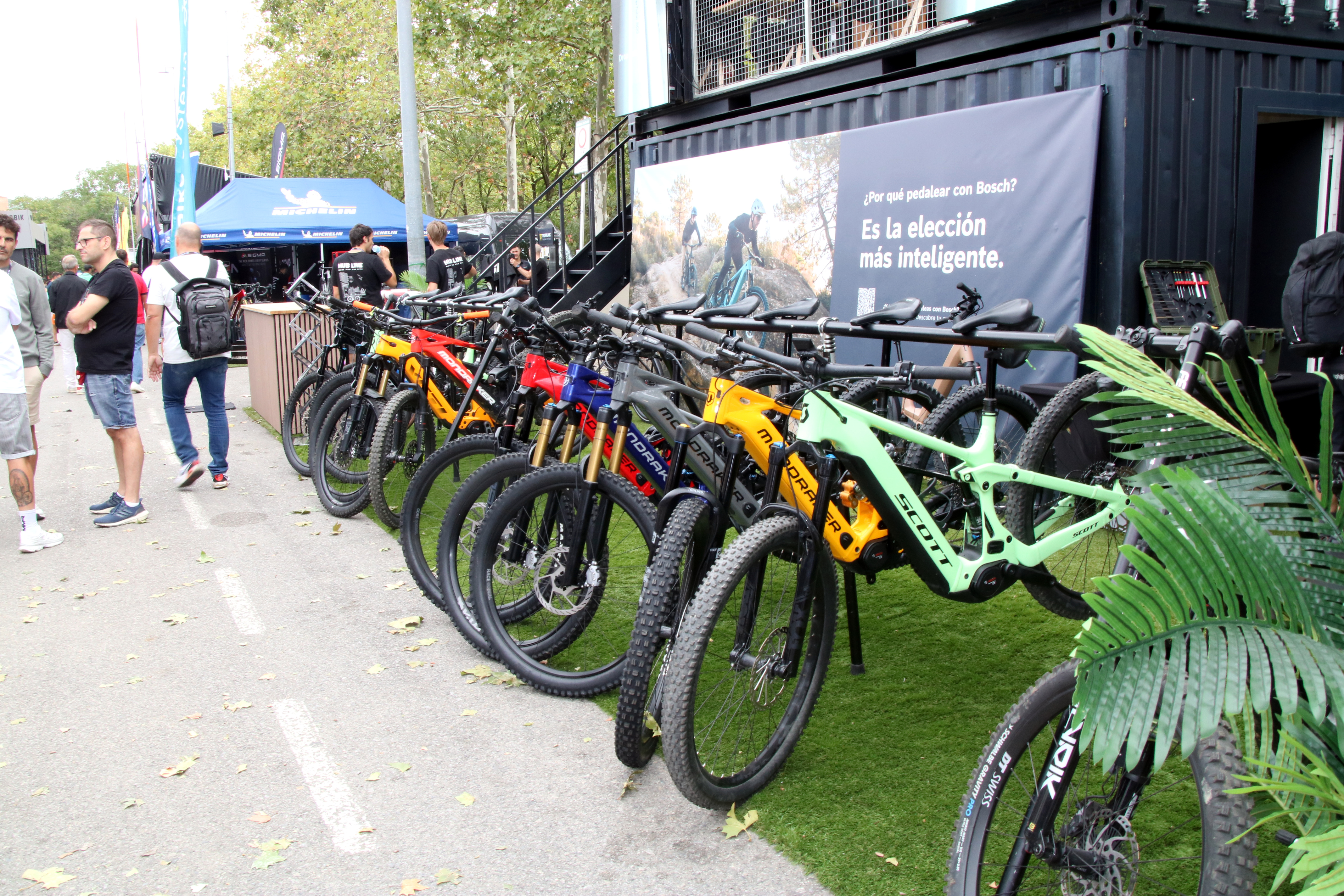 Bicycles on display and people strolling at Sea Otter this Friday.