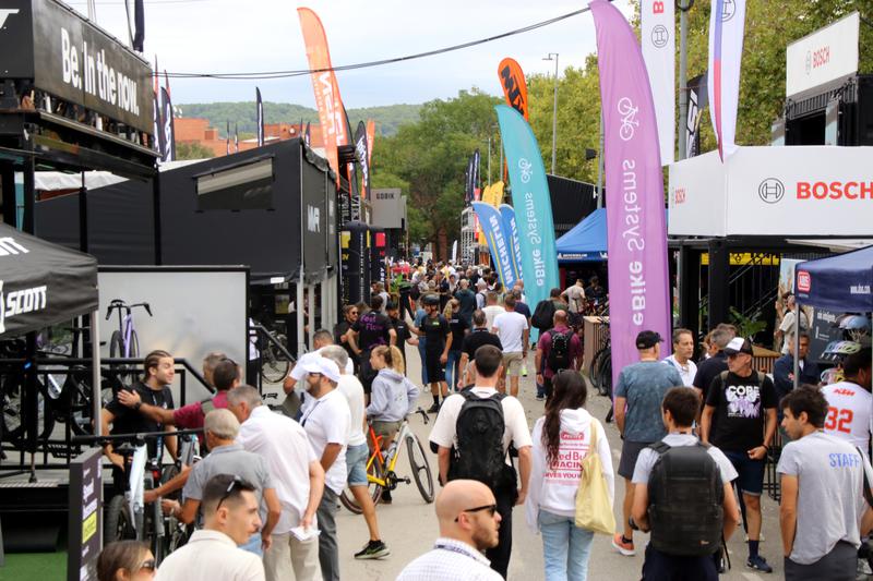 People strolling past a row of booths at the Sea Otter cycling festival