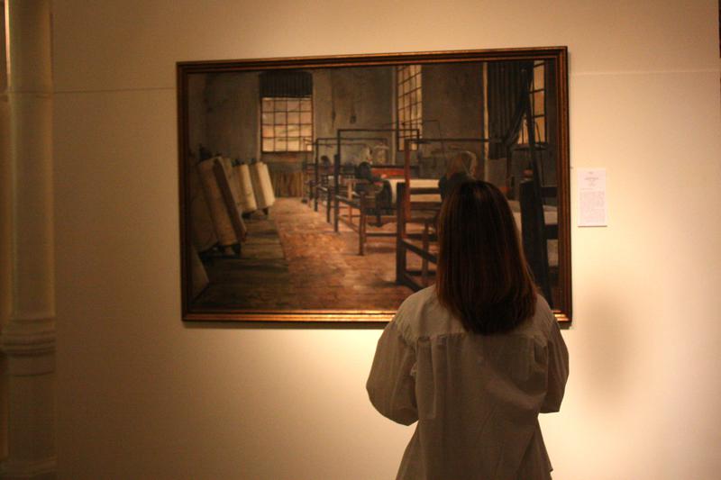 A woman looks at a painting from Santiago Rusiñol in a modernism exhibition in Barcelona