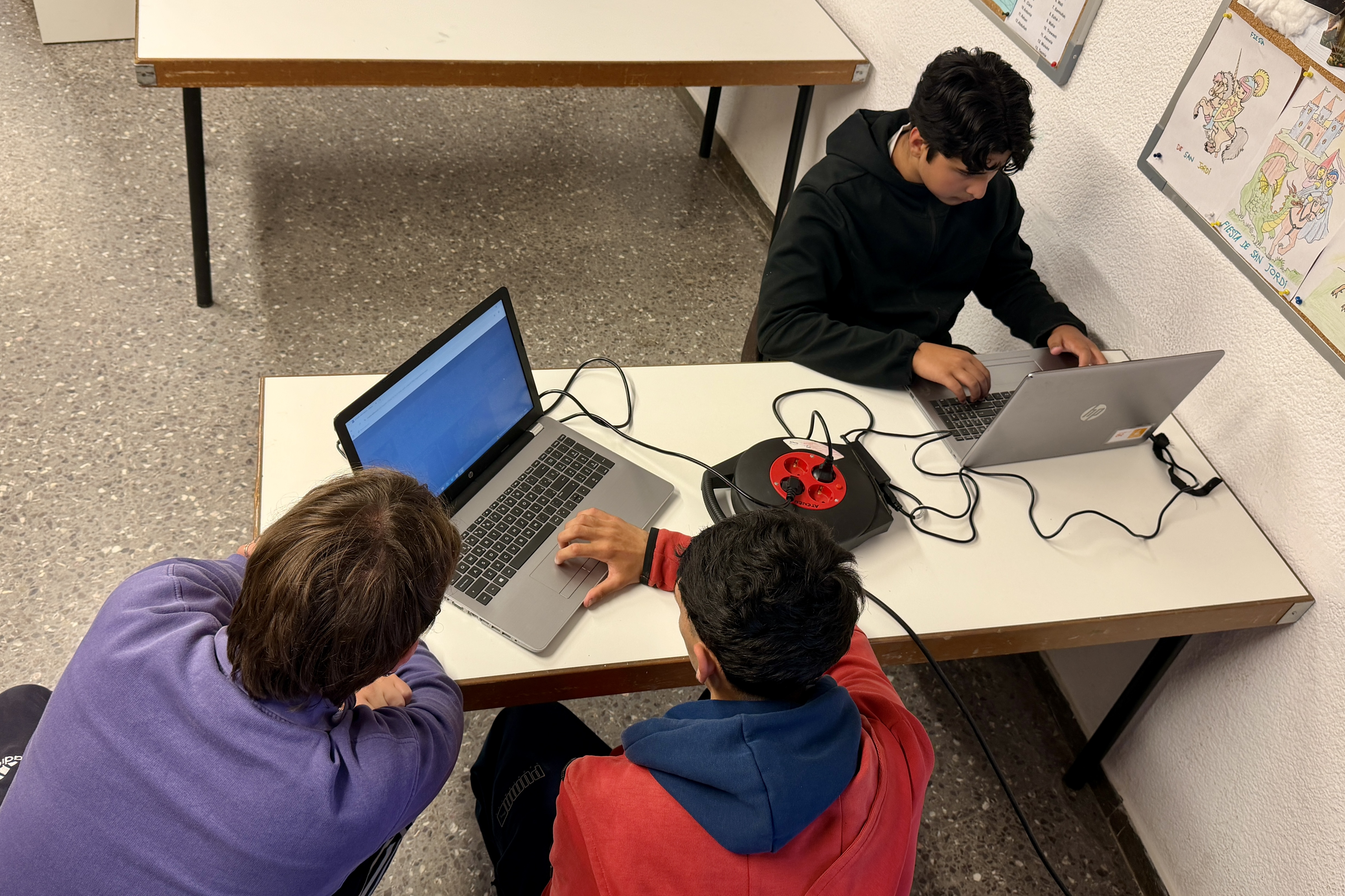 A group of young people do their homework in one of the classrooms at the Ateneu Sant Roc Foundation in Badalona