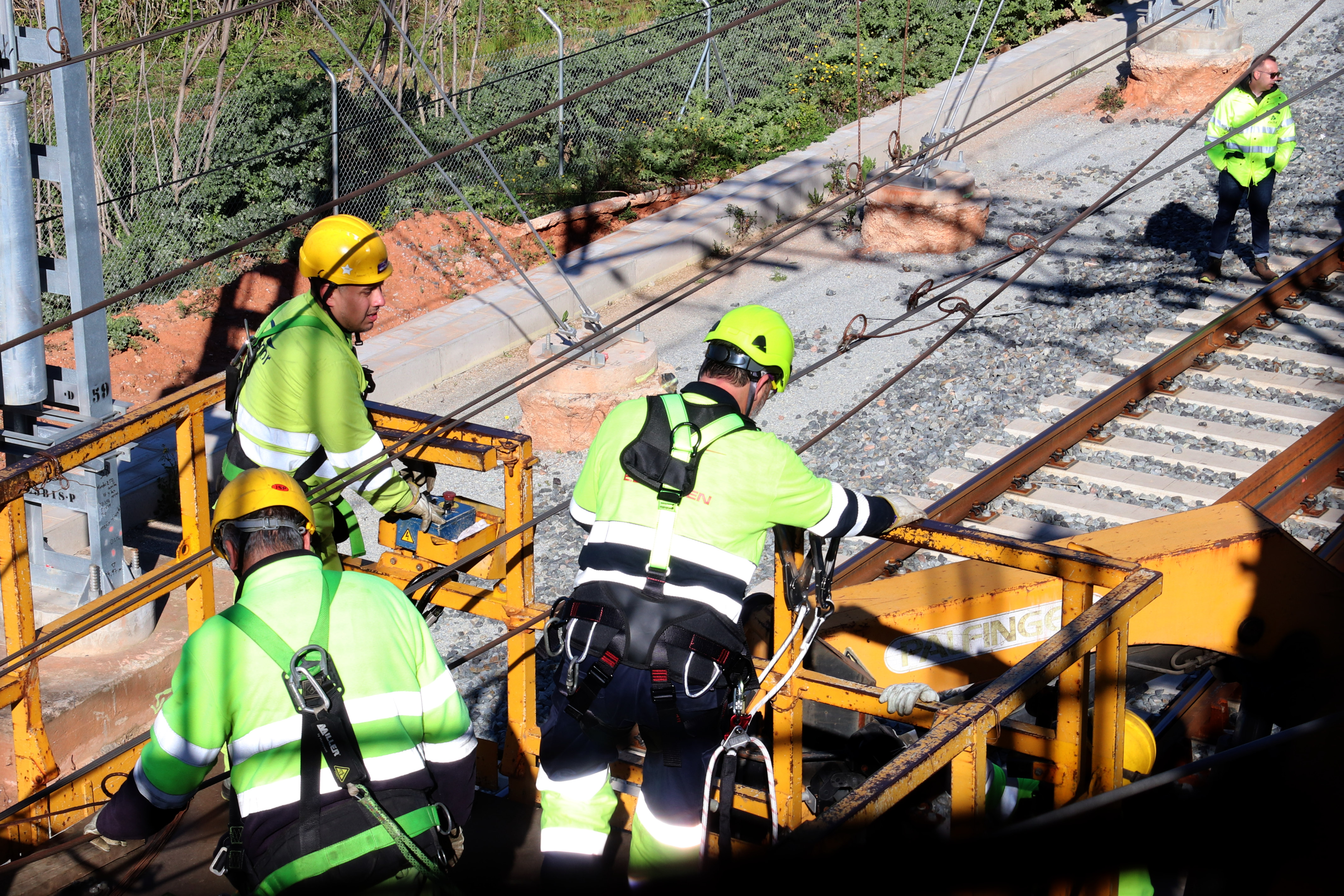 Technicians working on an electrical failure on the Rodalies commuter rail system