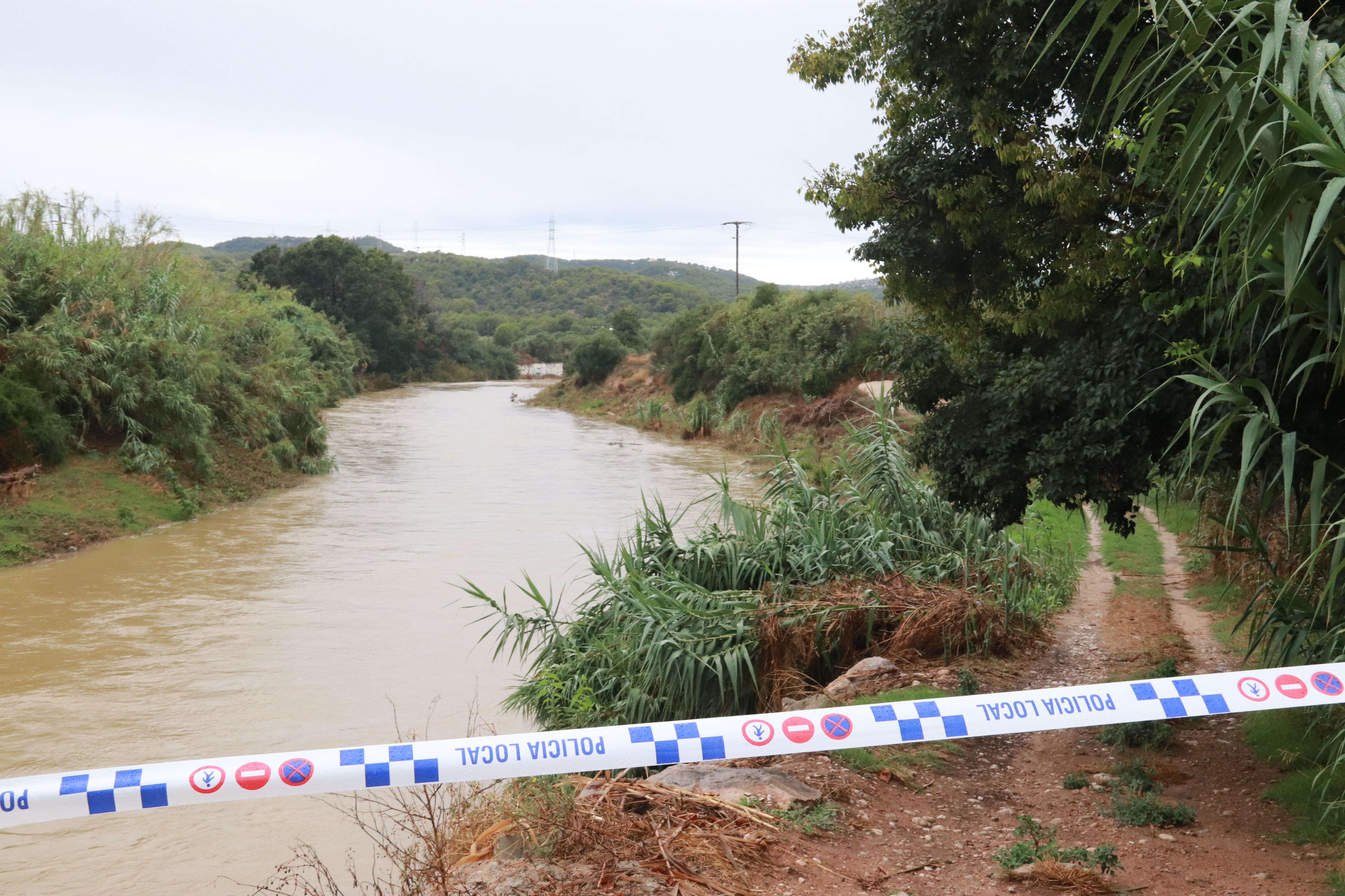 Cubelles police cordon off a path beside the Foix River
