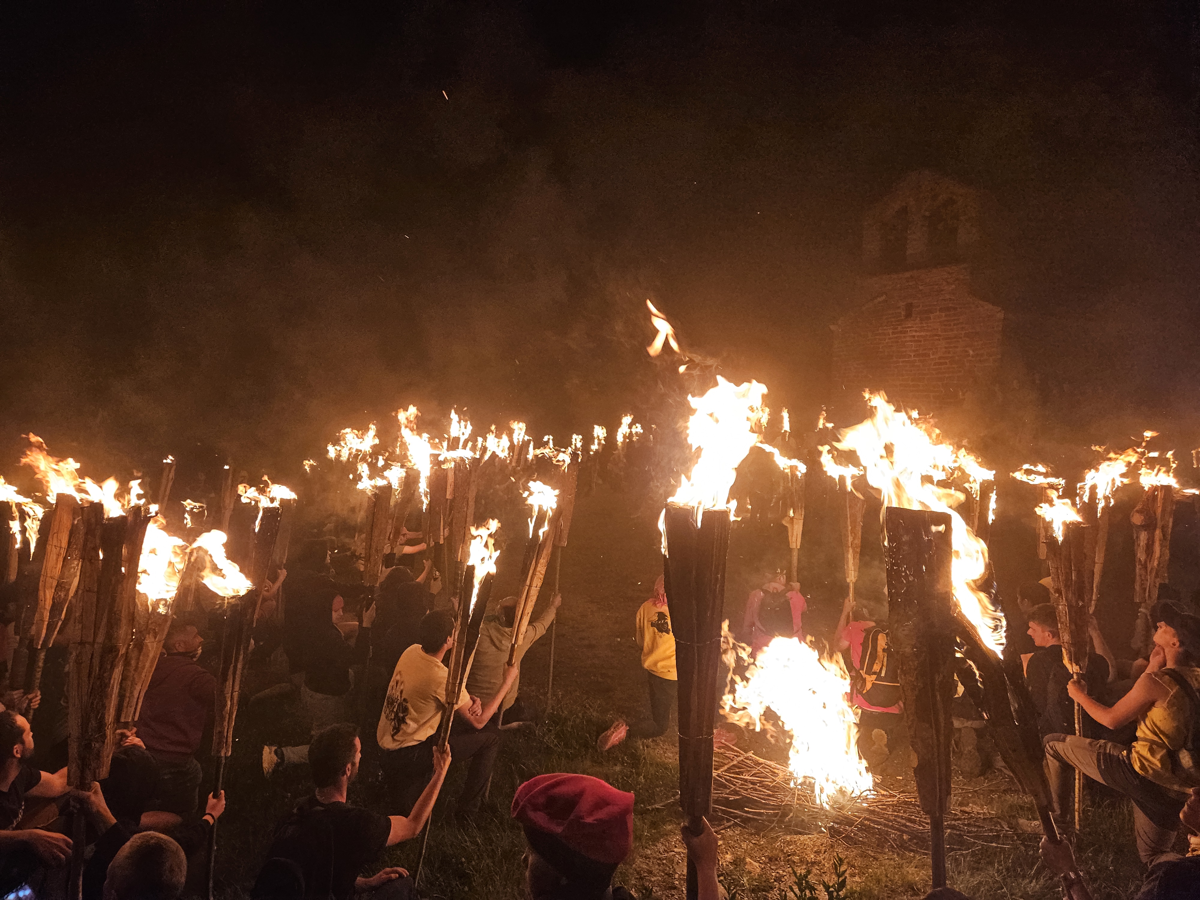Fallaires with the lit fallas in Sant Quirc, kneeling to remember the fallaires who are no longer there.