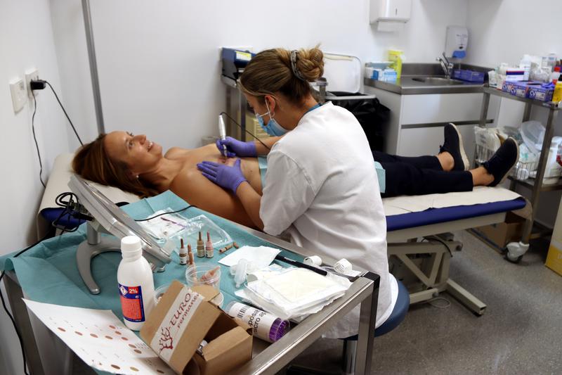 Alba Segura, a breast cancer survivor, goes through a new procedure to rebuild its breast after surviving the disease at Igualada Hospital