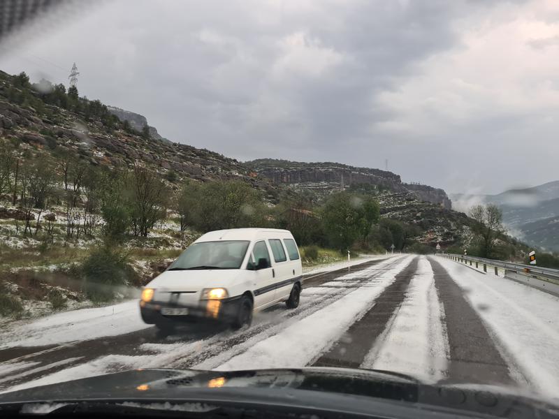 Catalonia's C-13 road between Pobla de Segur and Gerri de la Sal, covered with hail after a heave rain on June 29, 2023