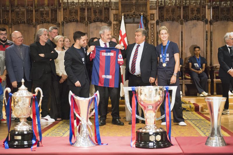 Jaume Collboni, mayor of Barcelona holding a Barça jersey with his name during the reception for Barça feminí's third Champions League victory