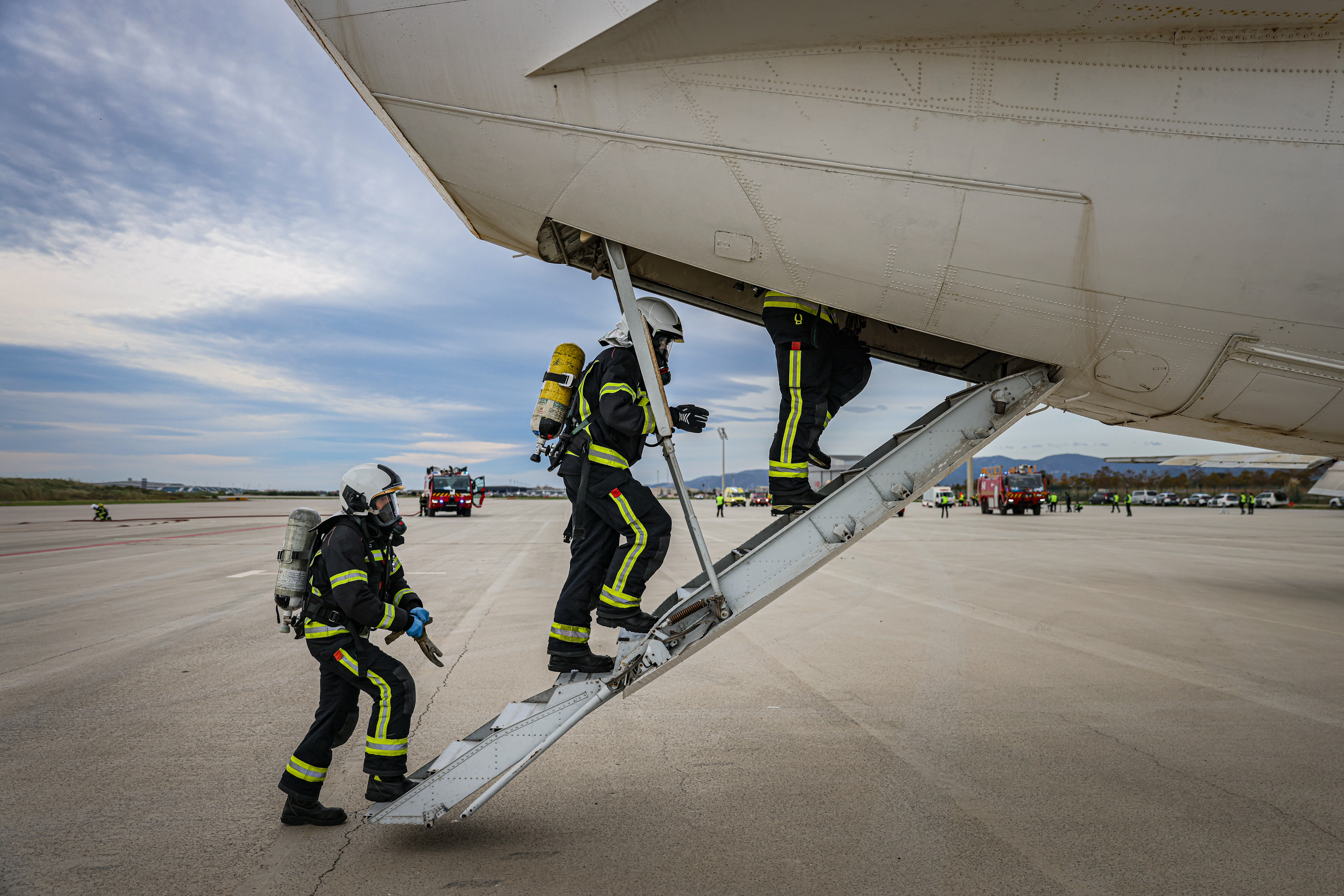 Firefighters entering the aircraft involved in the drill at Barcelona airport on November 20, 2024