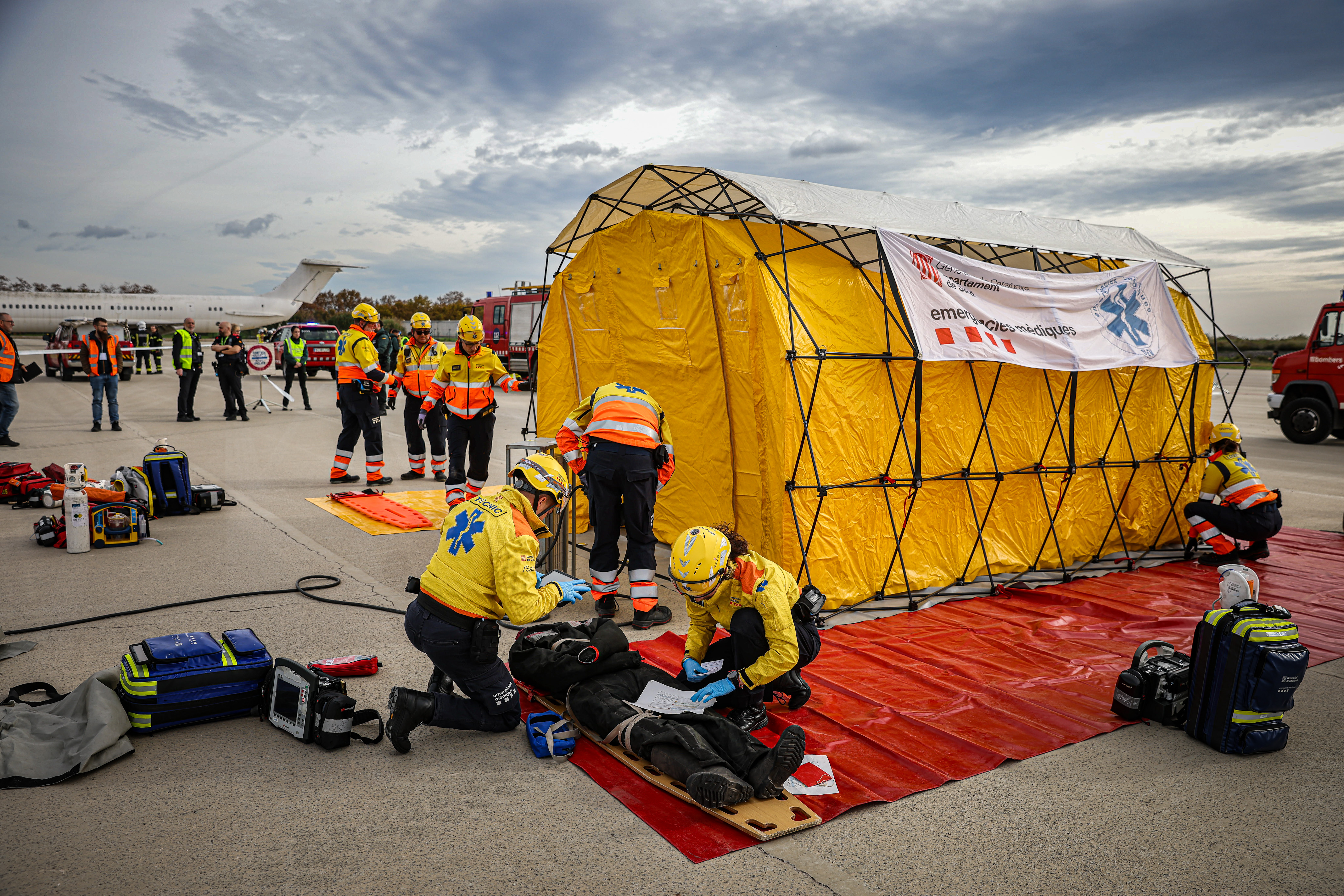 Emergency services assist victims during a drill at Barcelona airport on November 20, 2024