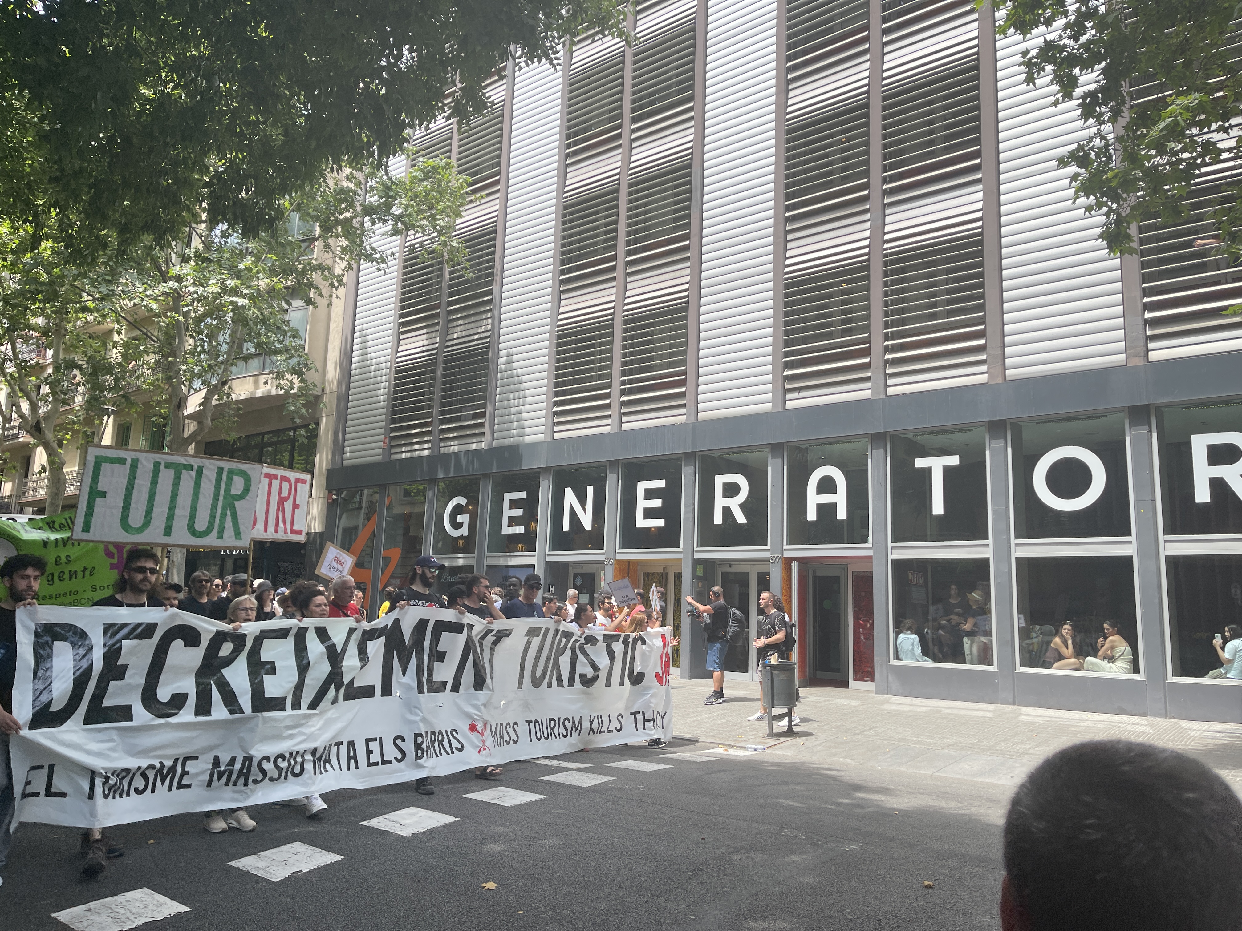 The head of march passes by the Generator hostel before protesters target it
