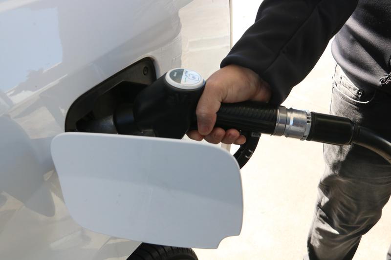 A driver fills their car up with petrol