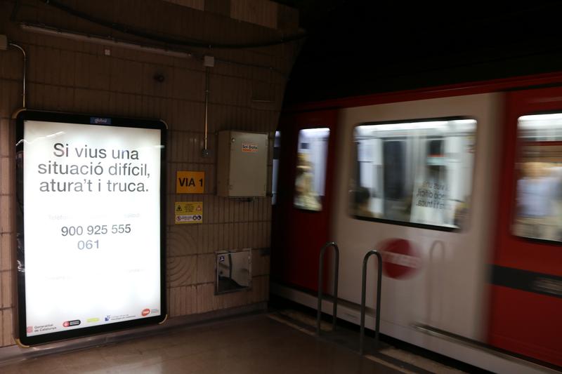 A suicide prevention campaign poster at the Guinardó-Hospital de Sant Pau metro station on L4