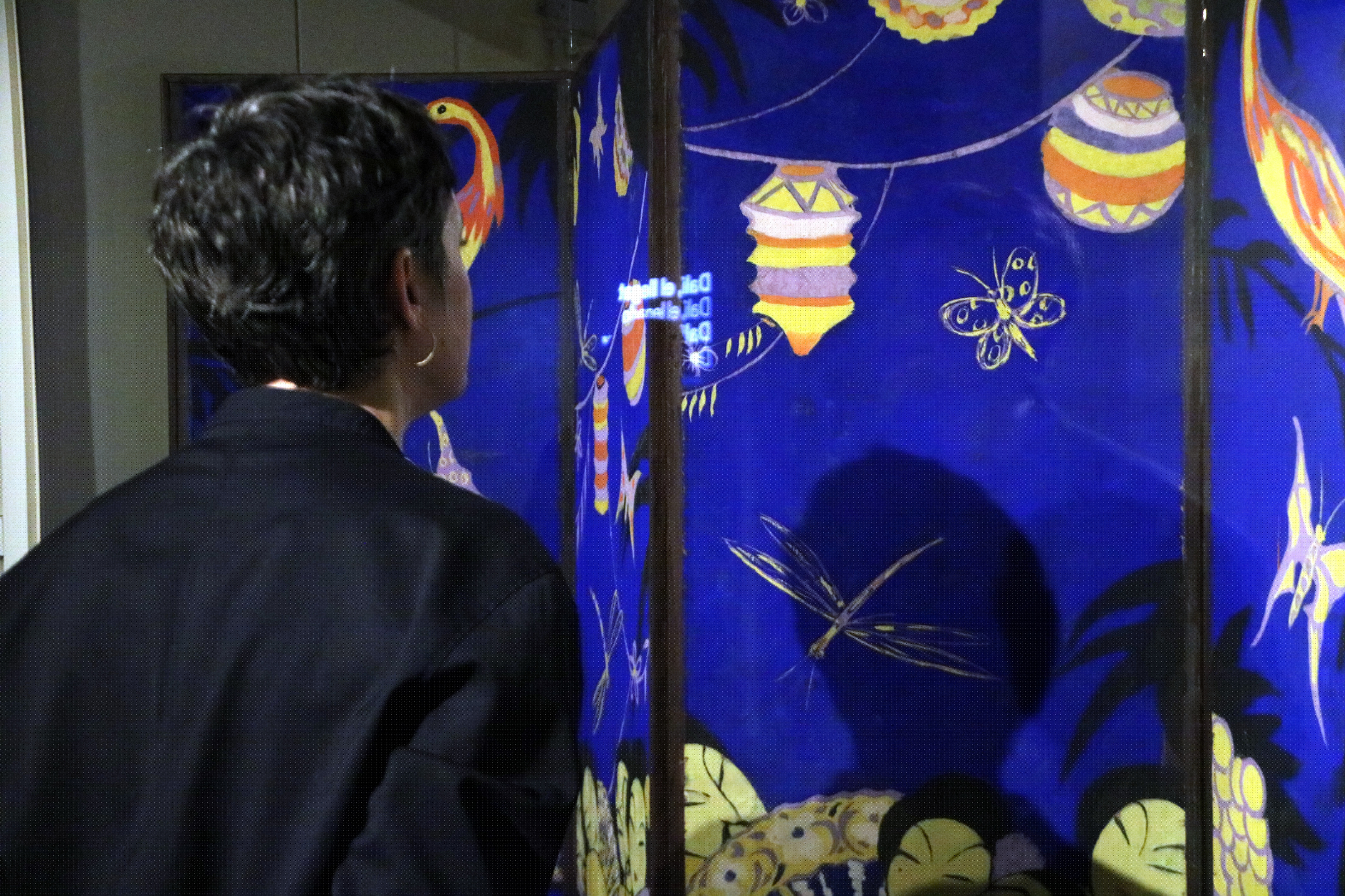 A woman observing Dalí's screen in Figueres