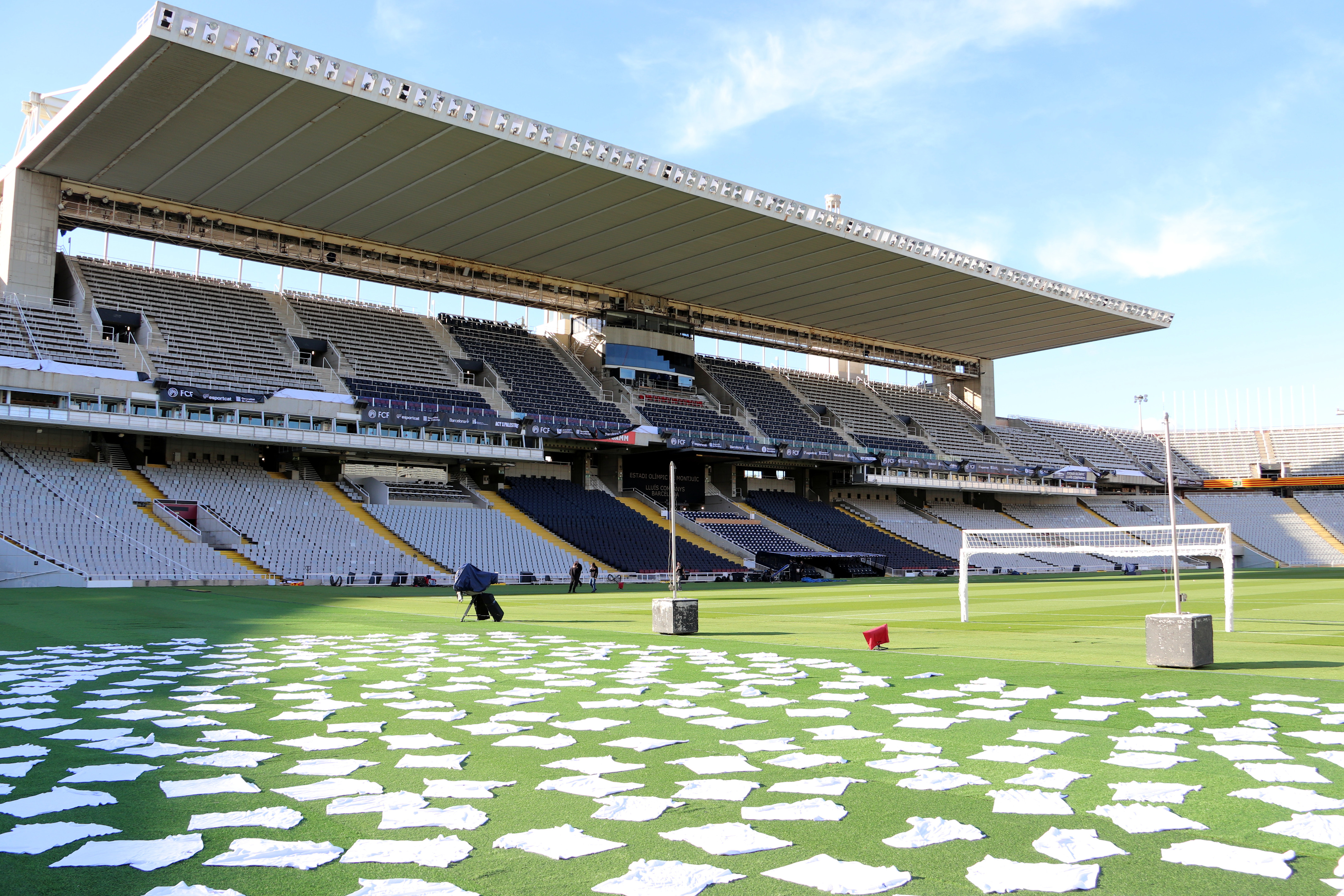 Organizers of the Catalonia-Palestine game lay out 400 white T-shirts at the stadium in tribute to Palestinian footballers killed in Israeli attacks