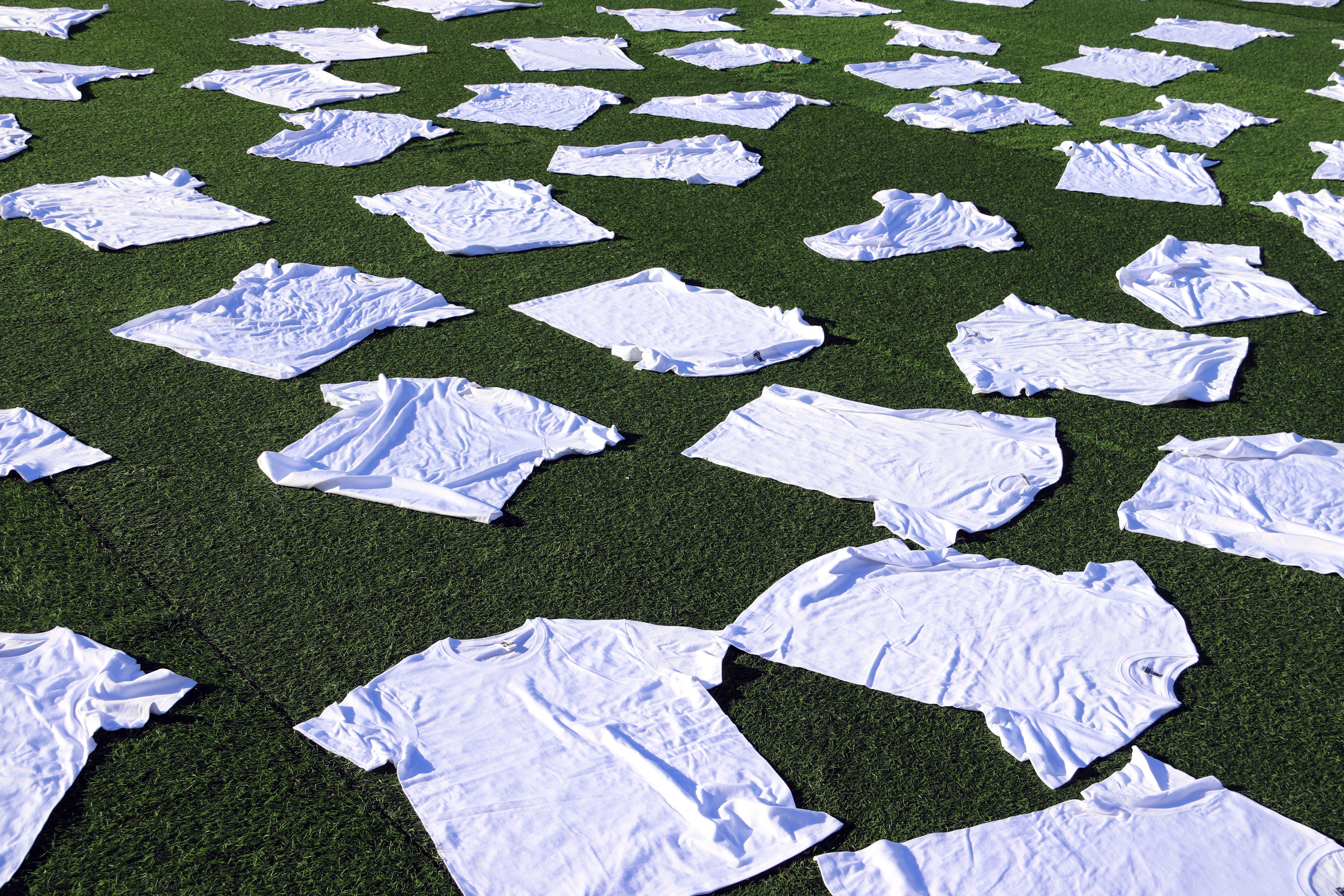 Organizers of the Catalonia-Palestine game lay out 400 white T-shirts at the stadium in tribute to Palestinian footballers killed in Israeli attacks