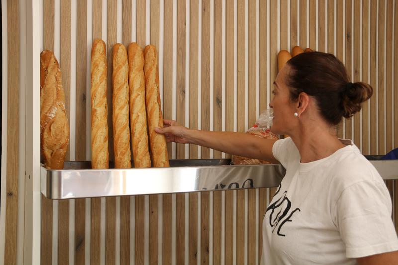 The owner of the new Cal Ventura bakery holding a loaf of bread
