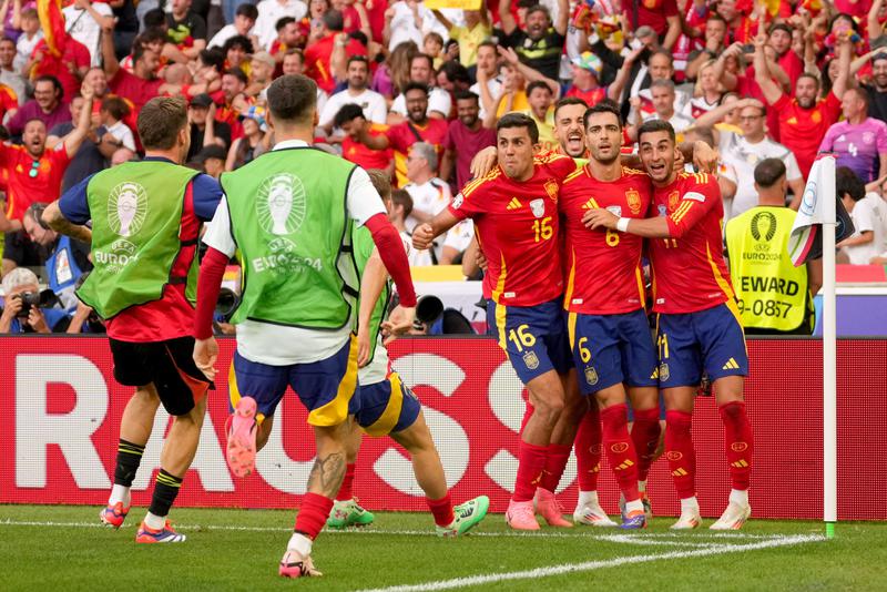 Mikel Merino of Spain celebrates with his teammates Rodri and Ferran Torres after scoring their team's second goal during the UEFA EURO 2024 quarter-final match between Spain and Germany at Stuttgart Arena on July 05, 2024 in Stuttgart, Germany