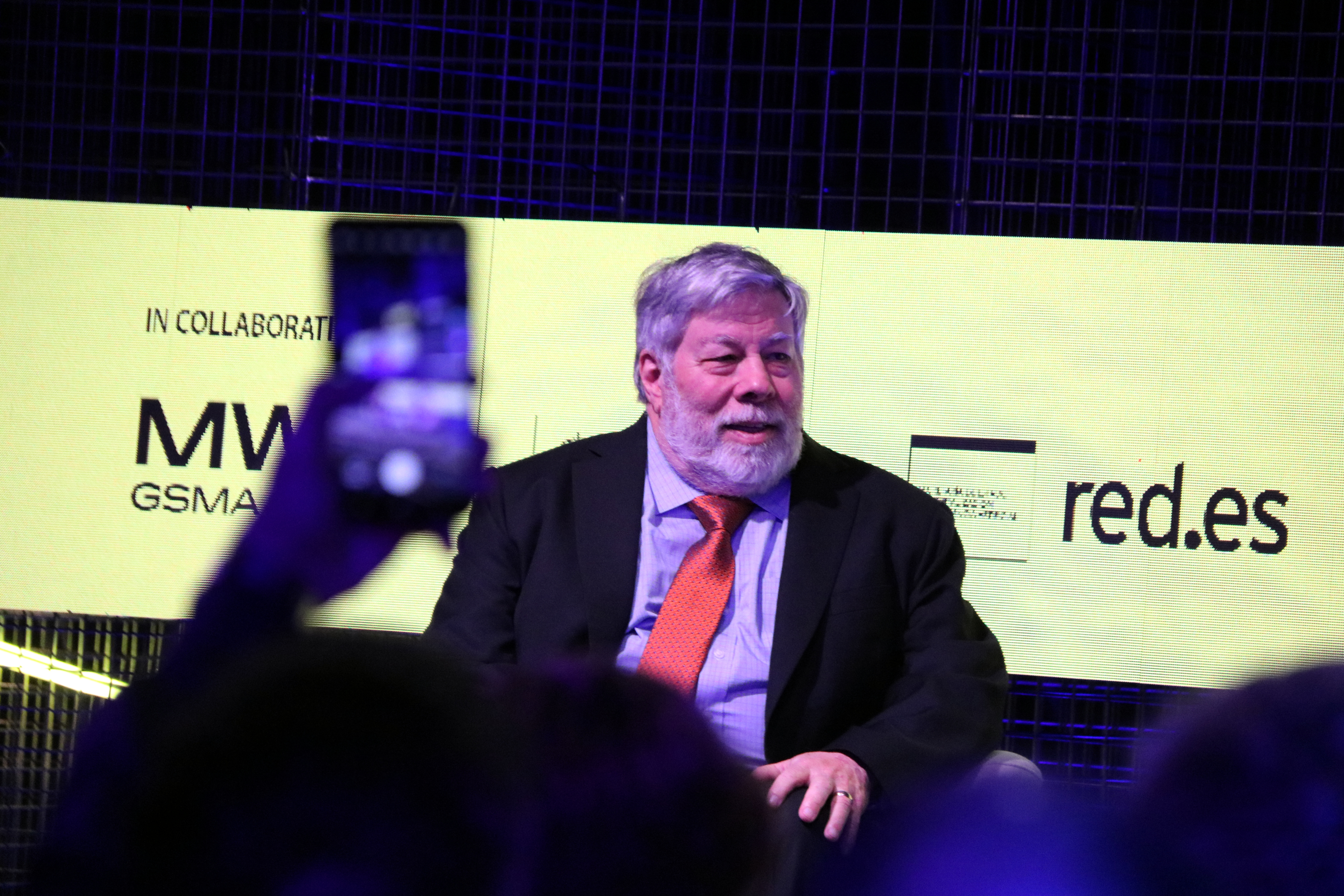 A phone takes a picture of Apple co-founder Steve Wozniak during a conference in Barcelona on March 4, 2025