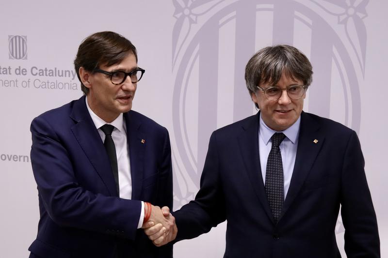 Catalan president Salvador Illa greets former Catalan president Carles Puigdemont in Brussels during a meeting on September 2, 2025