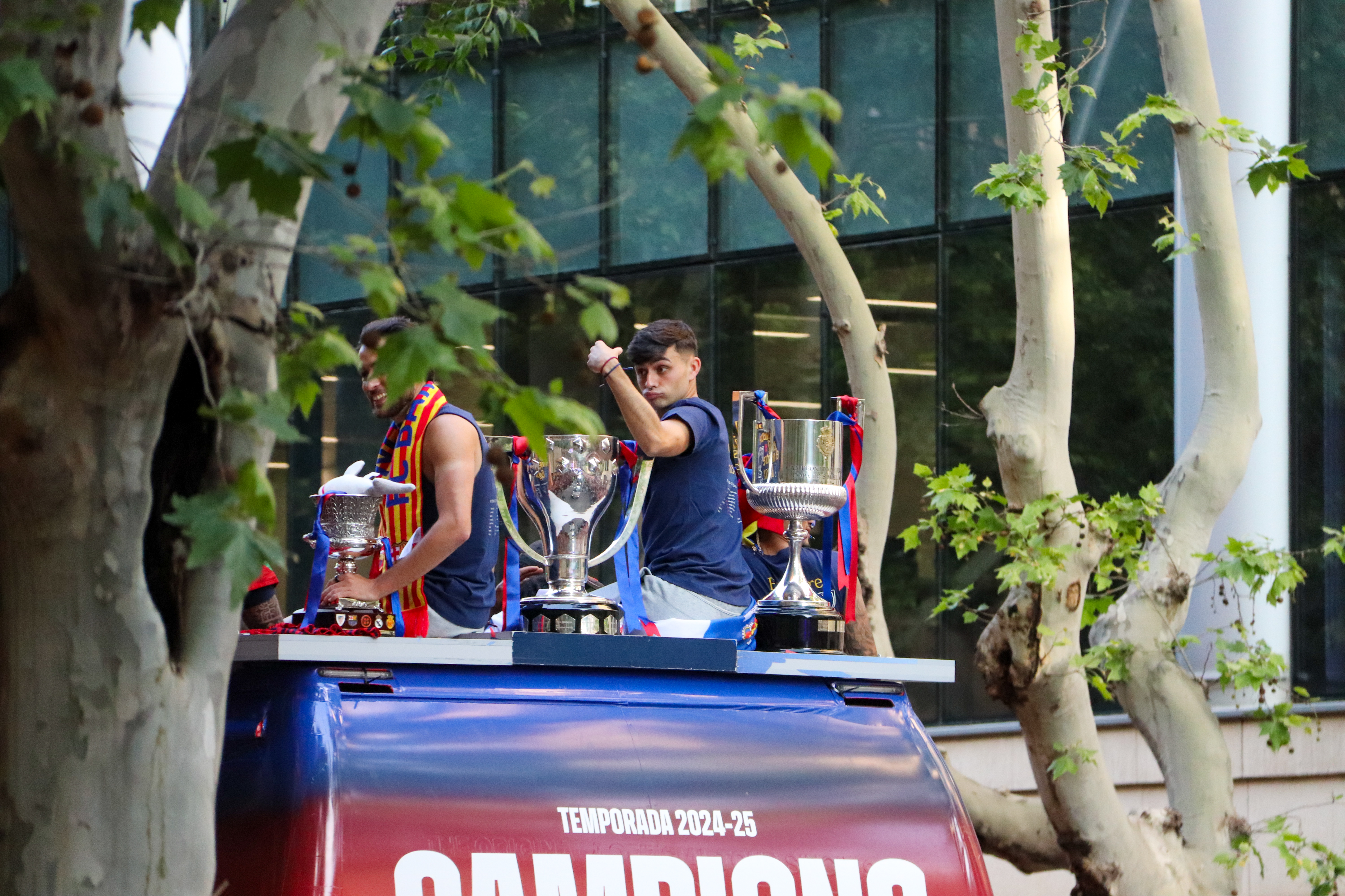 FC Barcelona midfielder Pedri on the team's open top bus parade with the La Liga, Copa del Rey, and Super Cup trophies