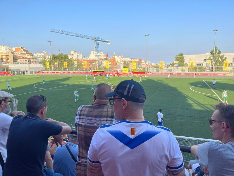 A CE Europa fan watches his team face CE Júpiter in the Torneig d'Històrics