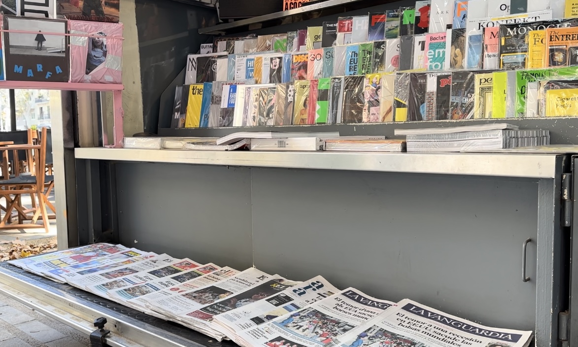 Different papers and magazines at a News and Coffee stand