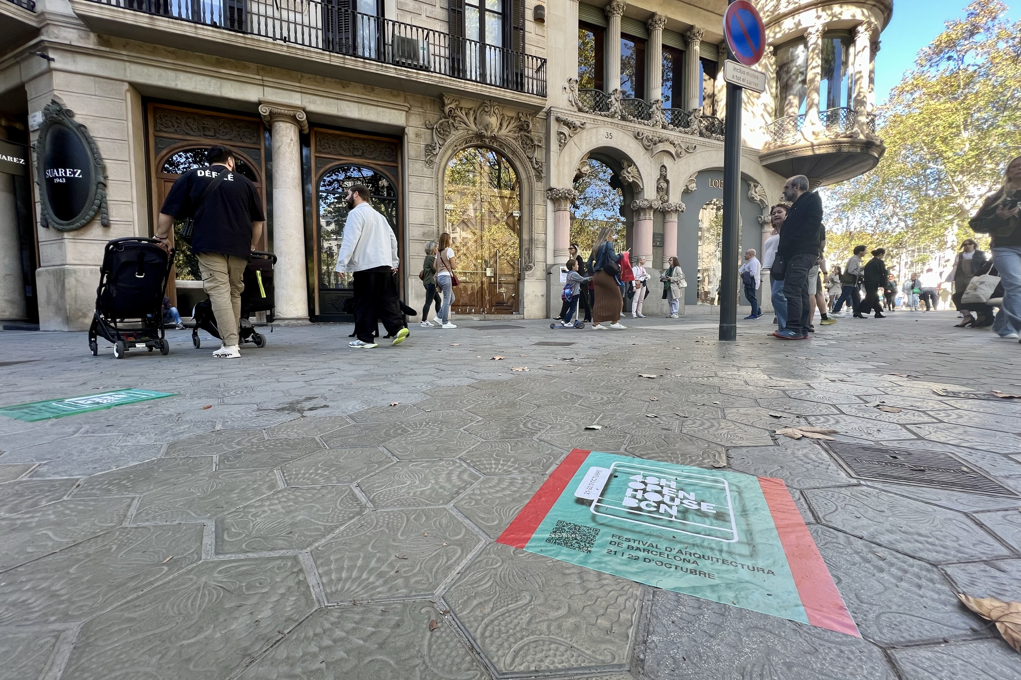 48H Open House logo printed on Barcelona's Passeig de Gràcia boulevard's floor in front of Catalan architect Lluís Domènech i Montaner's Lleó Morera house