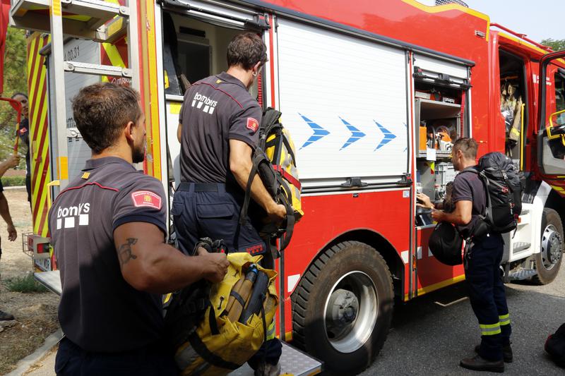Firefighters load material in one of the fire trucks, part of the convoy traveling to western Spain to help with the wildfires raging there