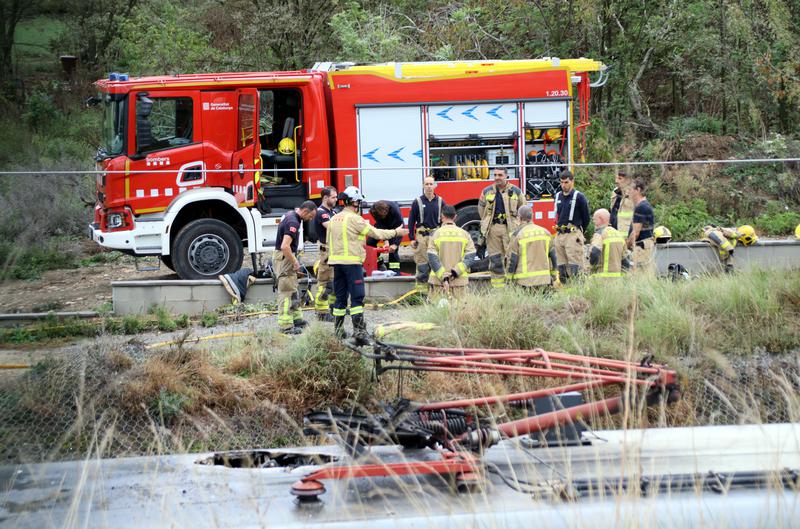 Firefighters work on a fire at a Rodalies R3 train that caused a partial suspension of the line on October 8, 2024